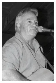 Musician performing live with guitar on stage