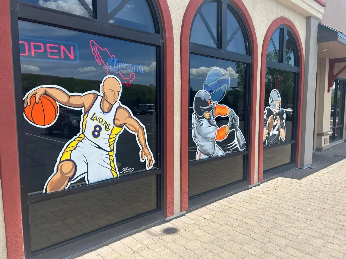 Colorful sports-themed restaurant window art