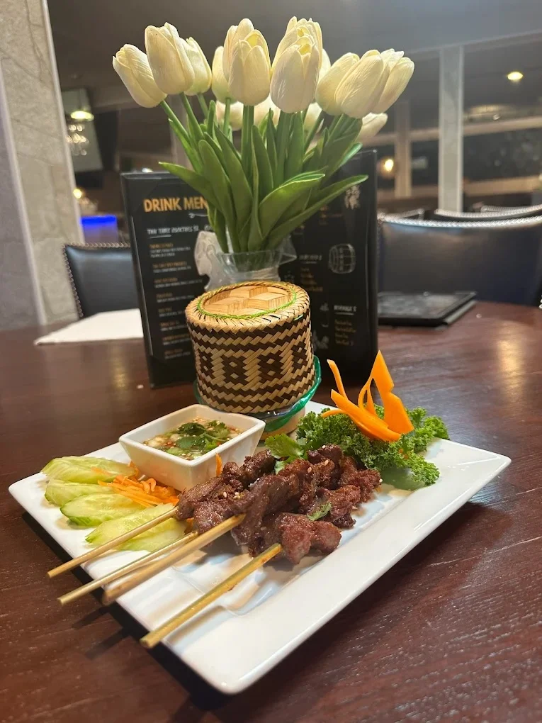 Thai satay skewers with peanut sauce and fresh vegetables