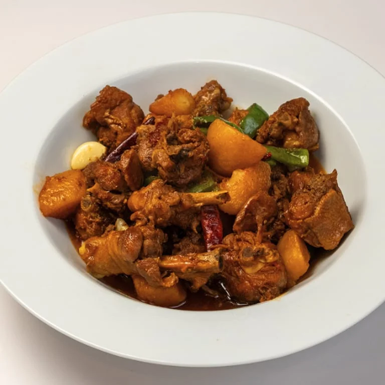 Spicy Indian chicken curry with potatoes and peppers