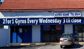 Gyro restaurant exterior with promotional signs