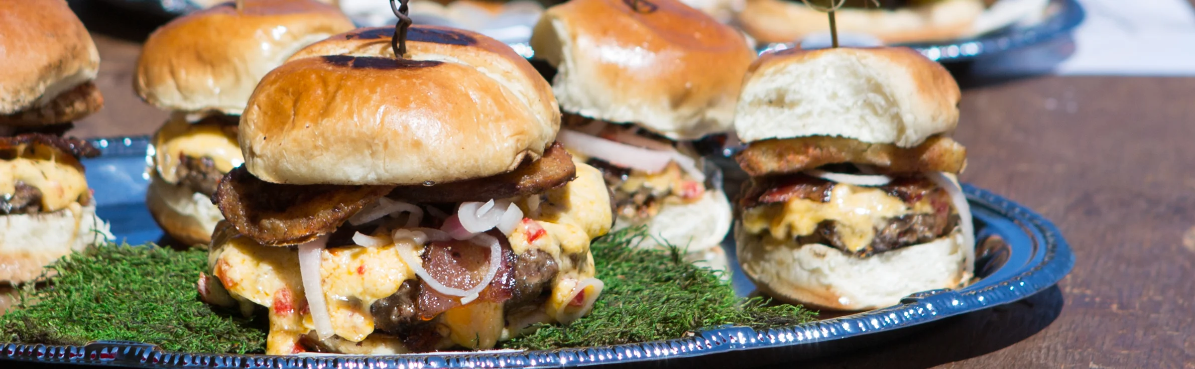 Gourmet sliders on a rustic wooden table