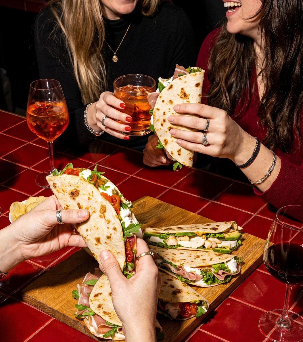 Italian piadina with prosciutto and fresh greens, paired with wine