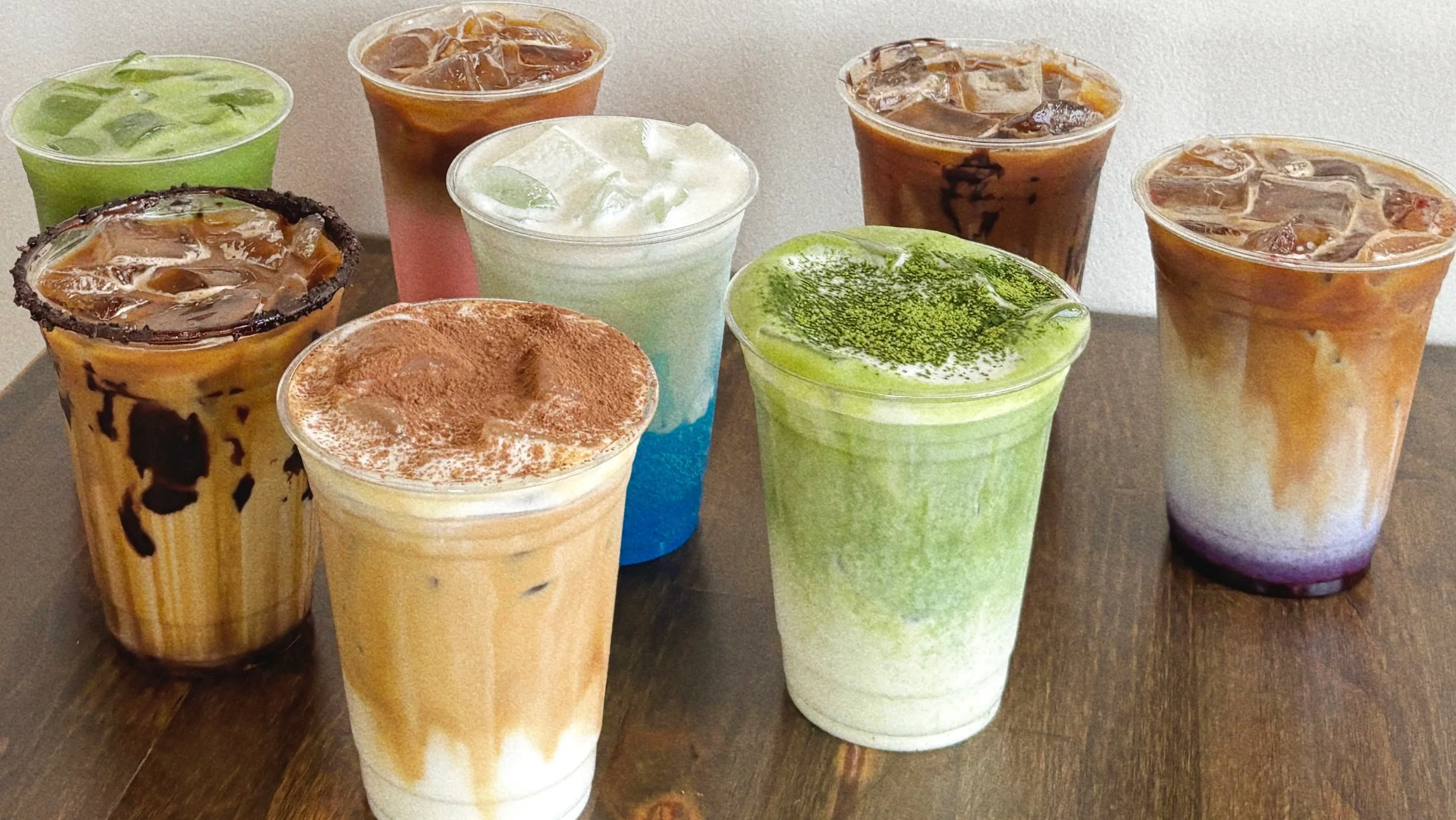 Variety of colorful iced beverages in clear cups