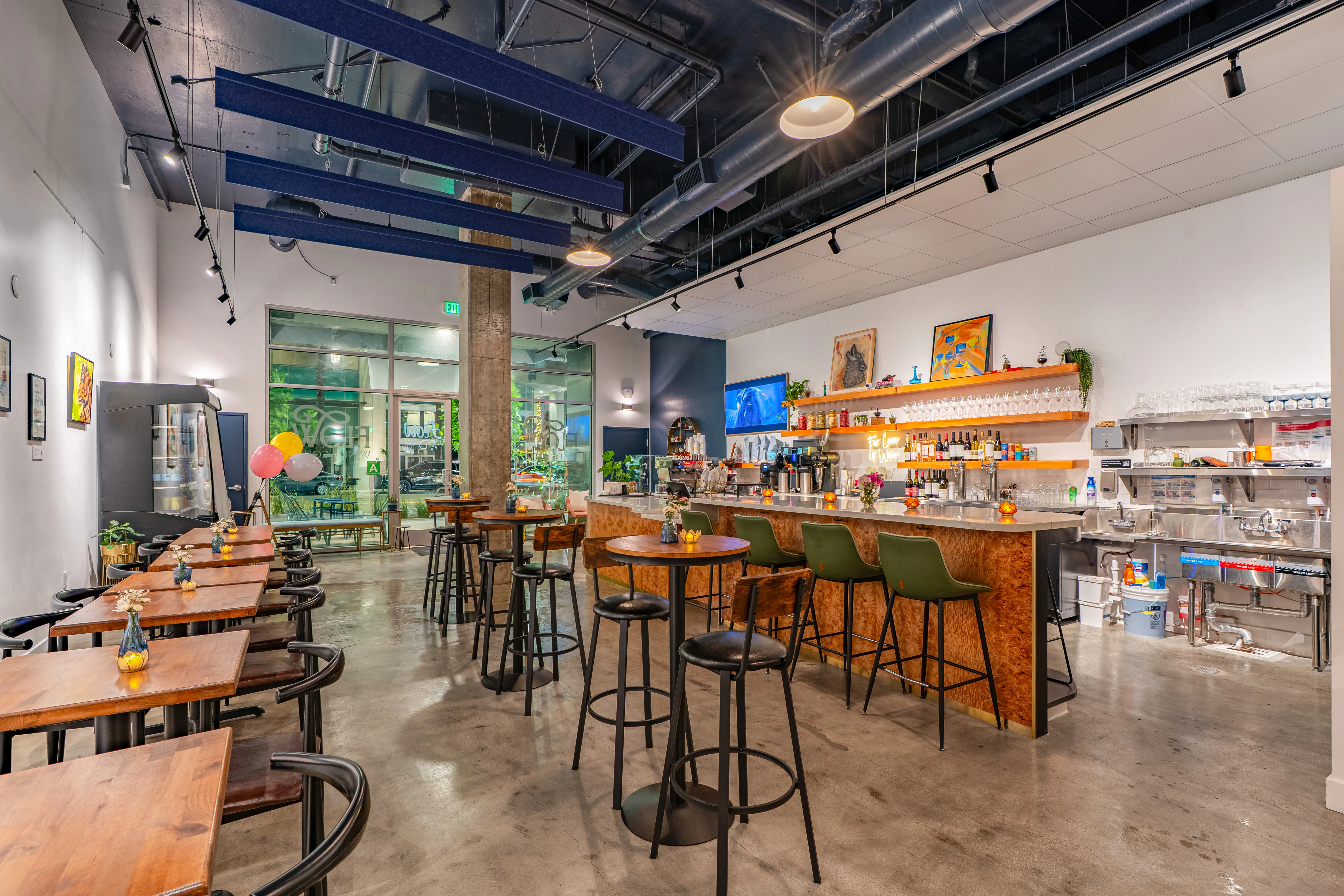 Interior of a modern restaurant with tables and wall art.