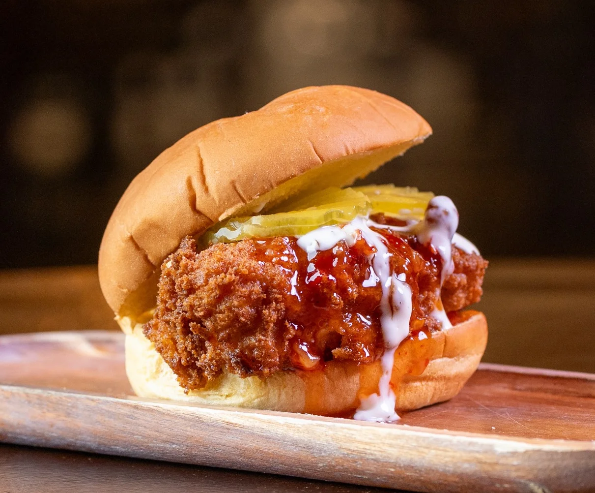 Delicious gourmet burger with fresh toppings on a wooden table