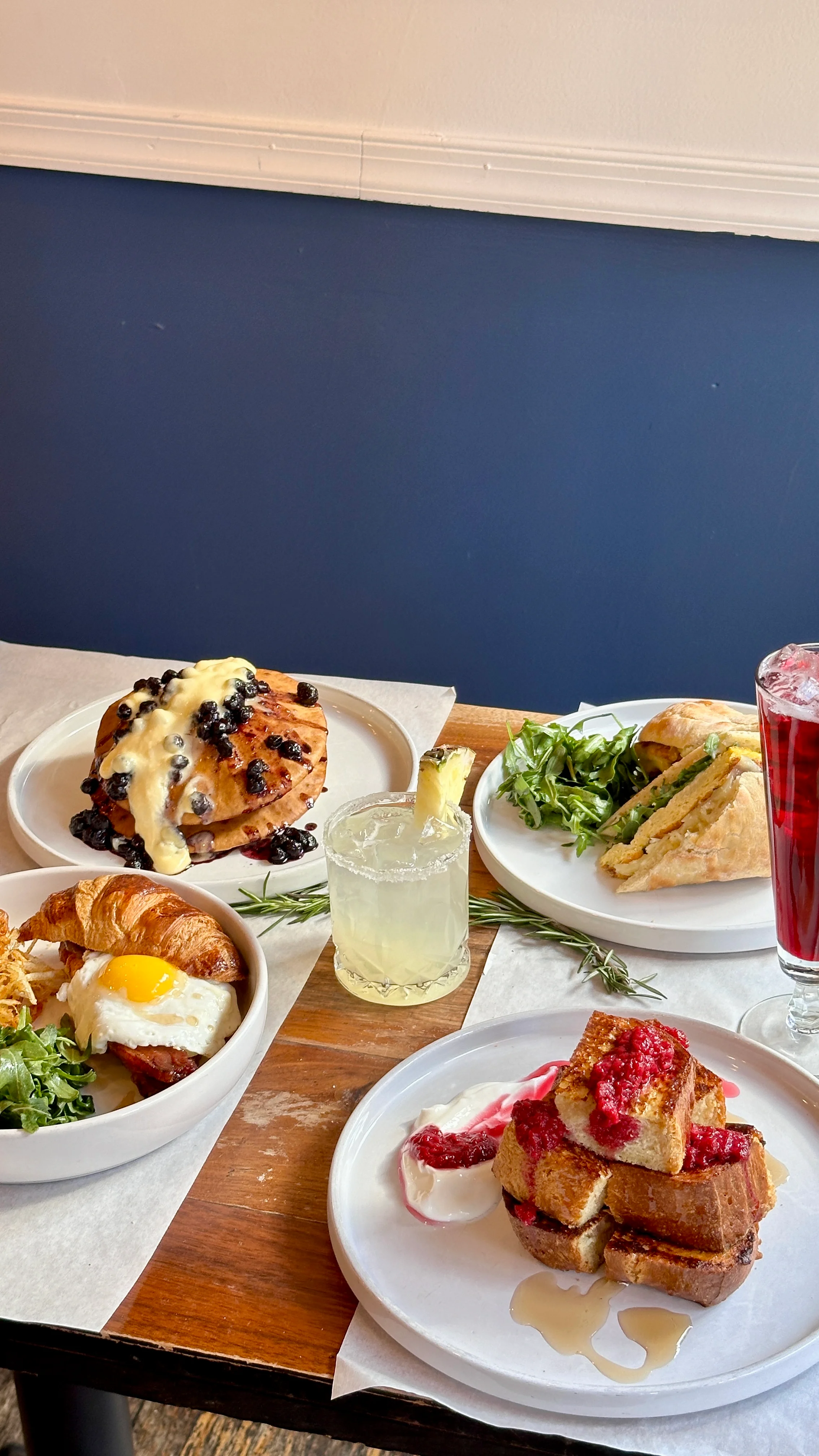 Delicious gourmet burger with fresh toppings on a wooden table.