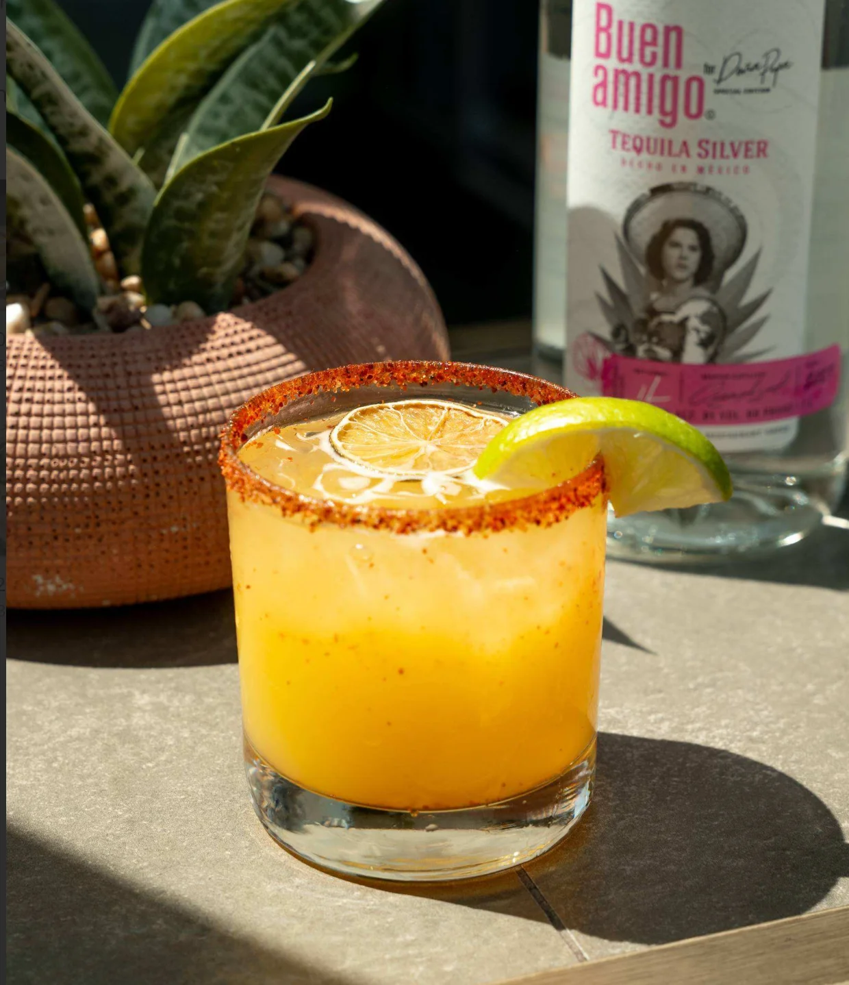 Vibrant margarita cocktail with lime garnish and chili rim
