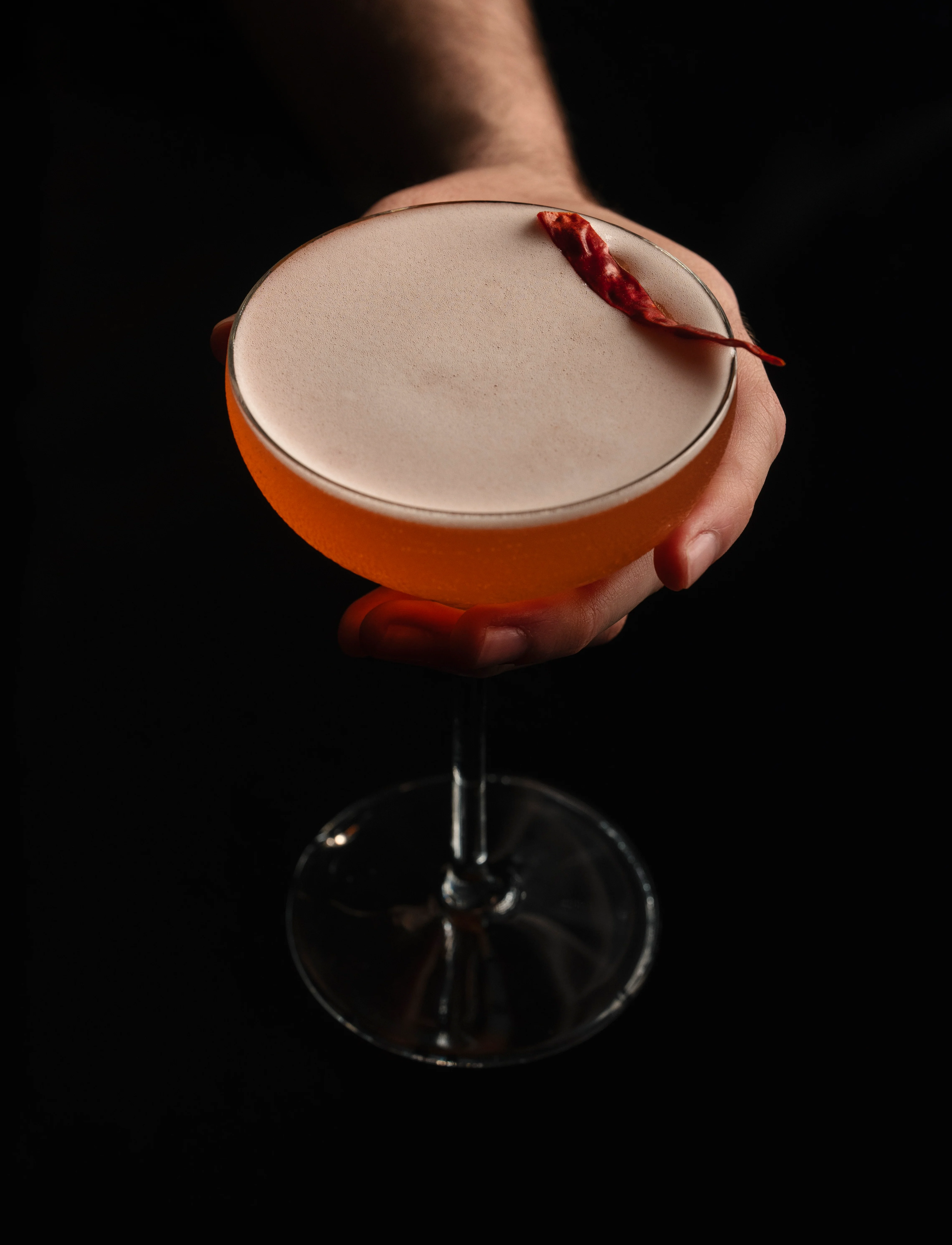Crafted espresso martini with a chocolate-dipped biscuit