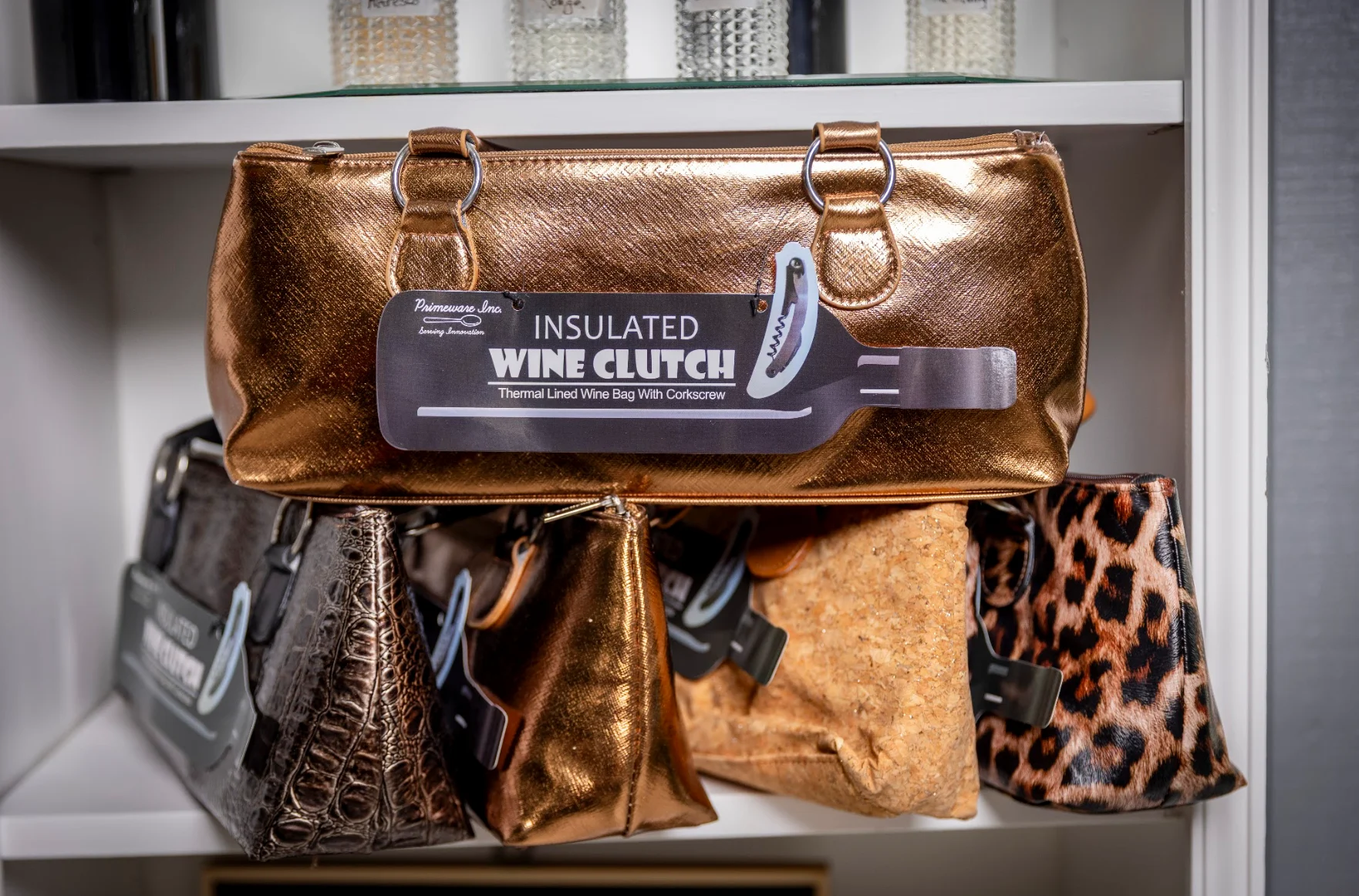 Stylish insulated wine clutches on display