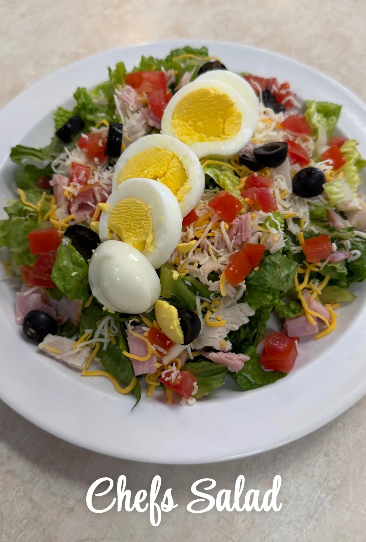 Classic American chef's salad with eggs and greens