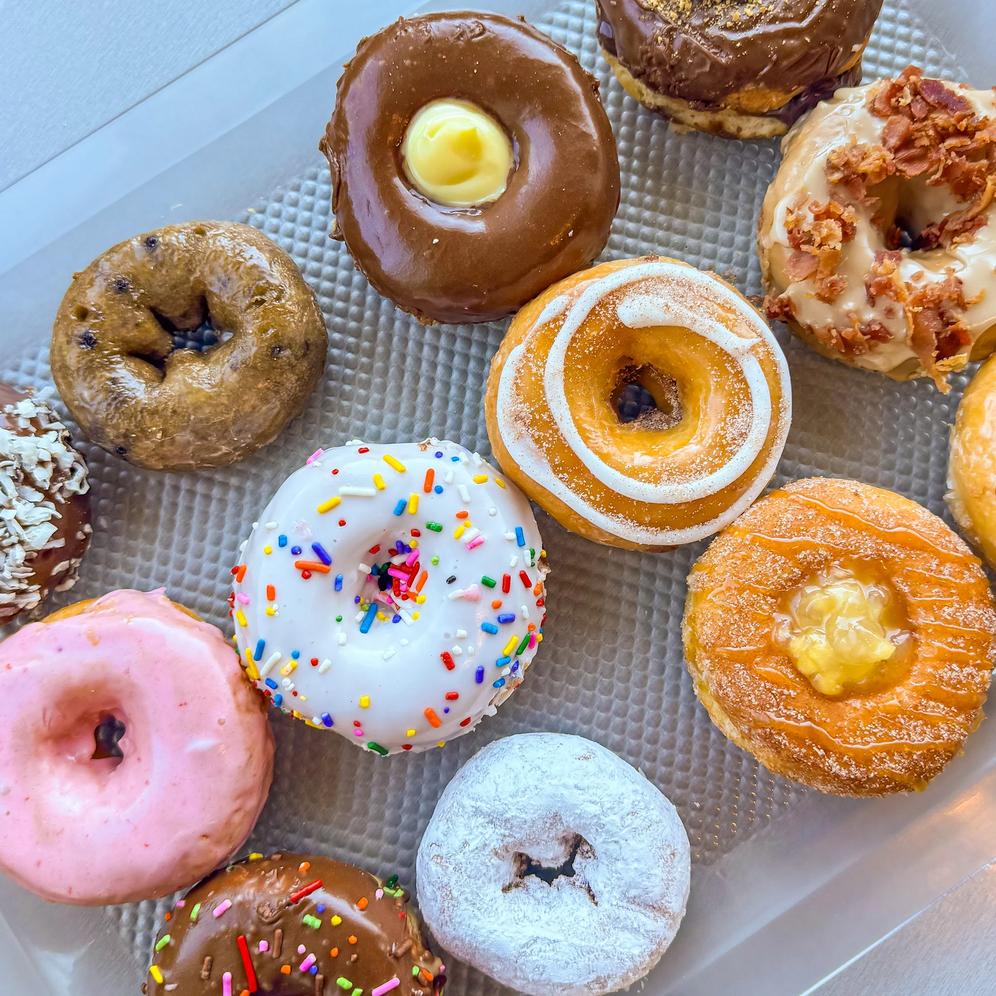 Assorted gourmet donuts on a tray