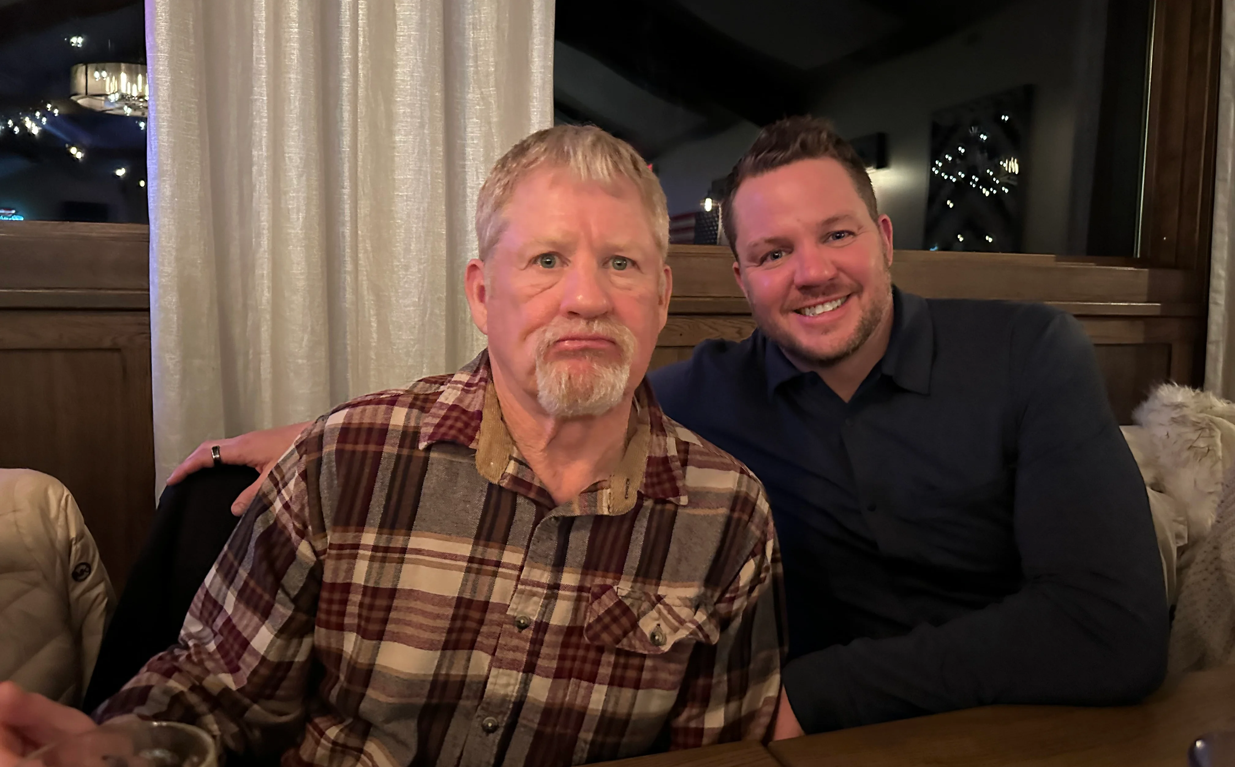 Two friends enjoying a meal in a cozy restaurant setting