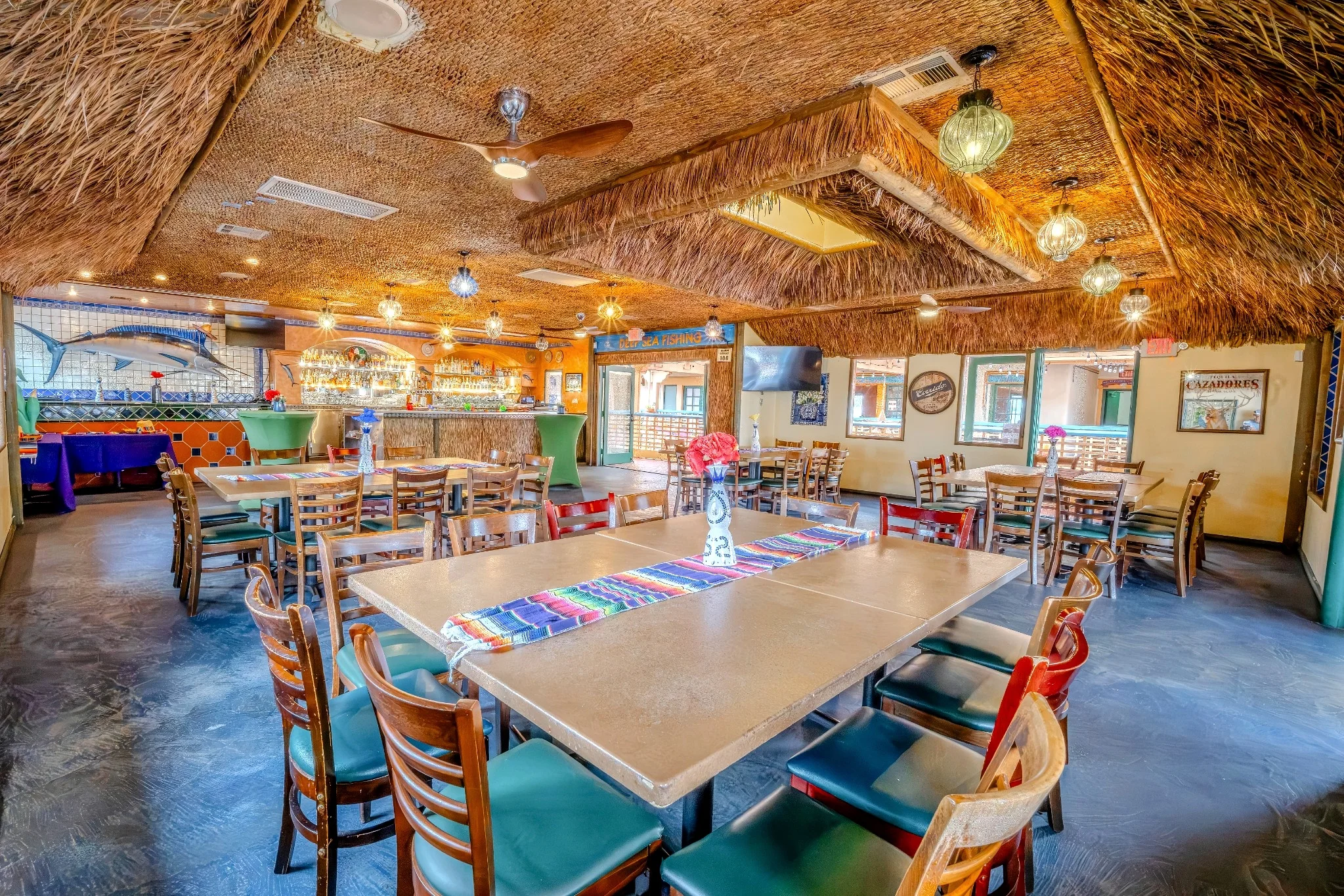 Cozy restaurant interior with tropical decor and seating