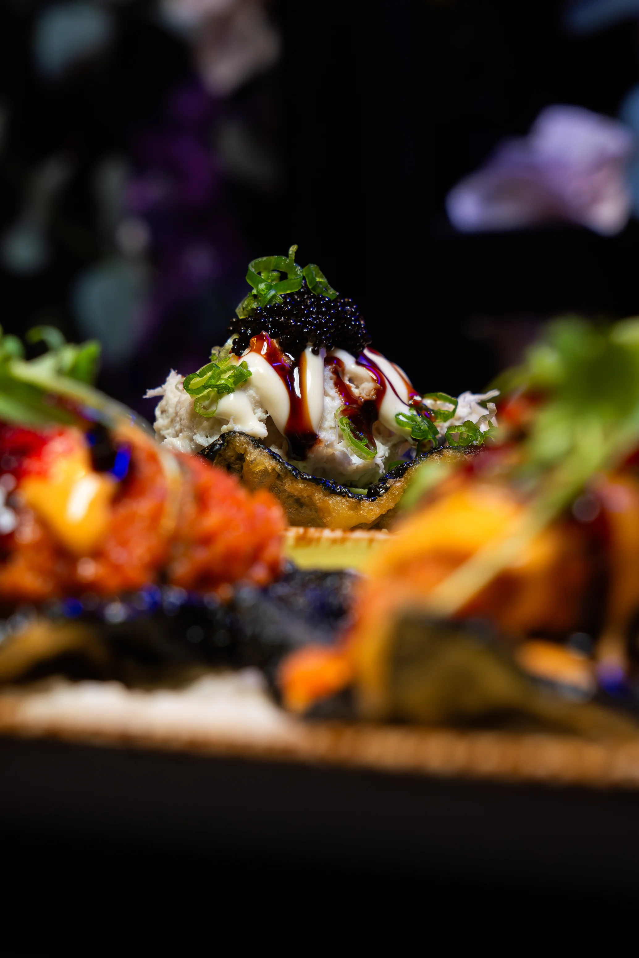 Japanese sushi rolls with colorful toppings and garnishes
