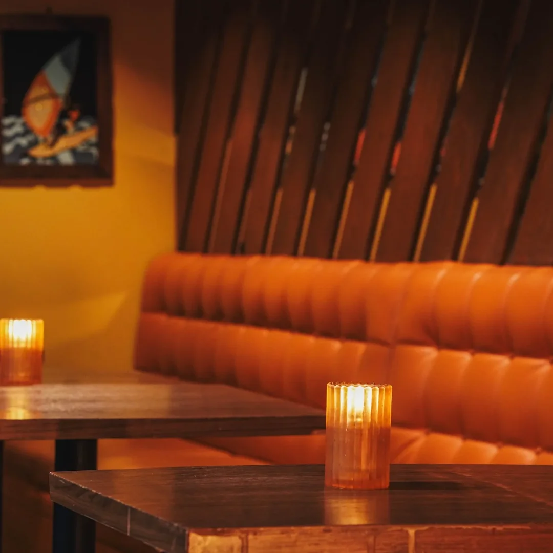 Cozy restaurant interior with warm lighting and orange seating