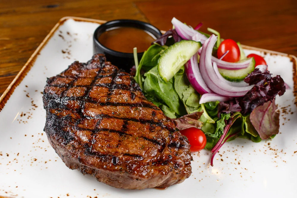 Grilled ribeye steak with fresh garden salad