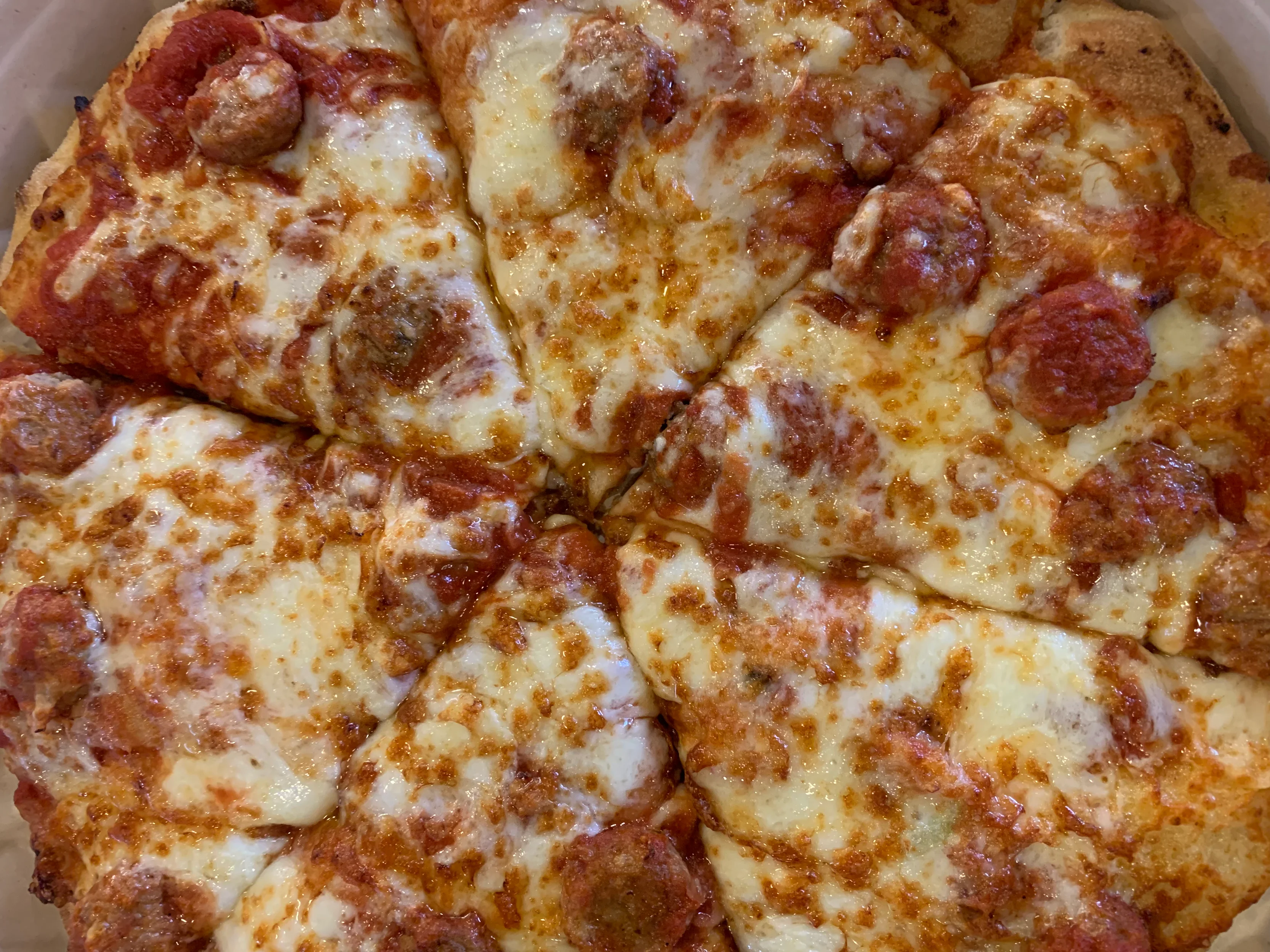 New! Charmy's Market now serves fresh, hot, made-to-order pizza's from its in-house kitchen.