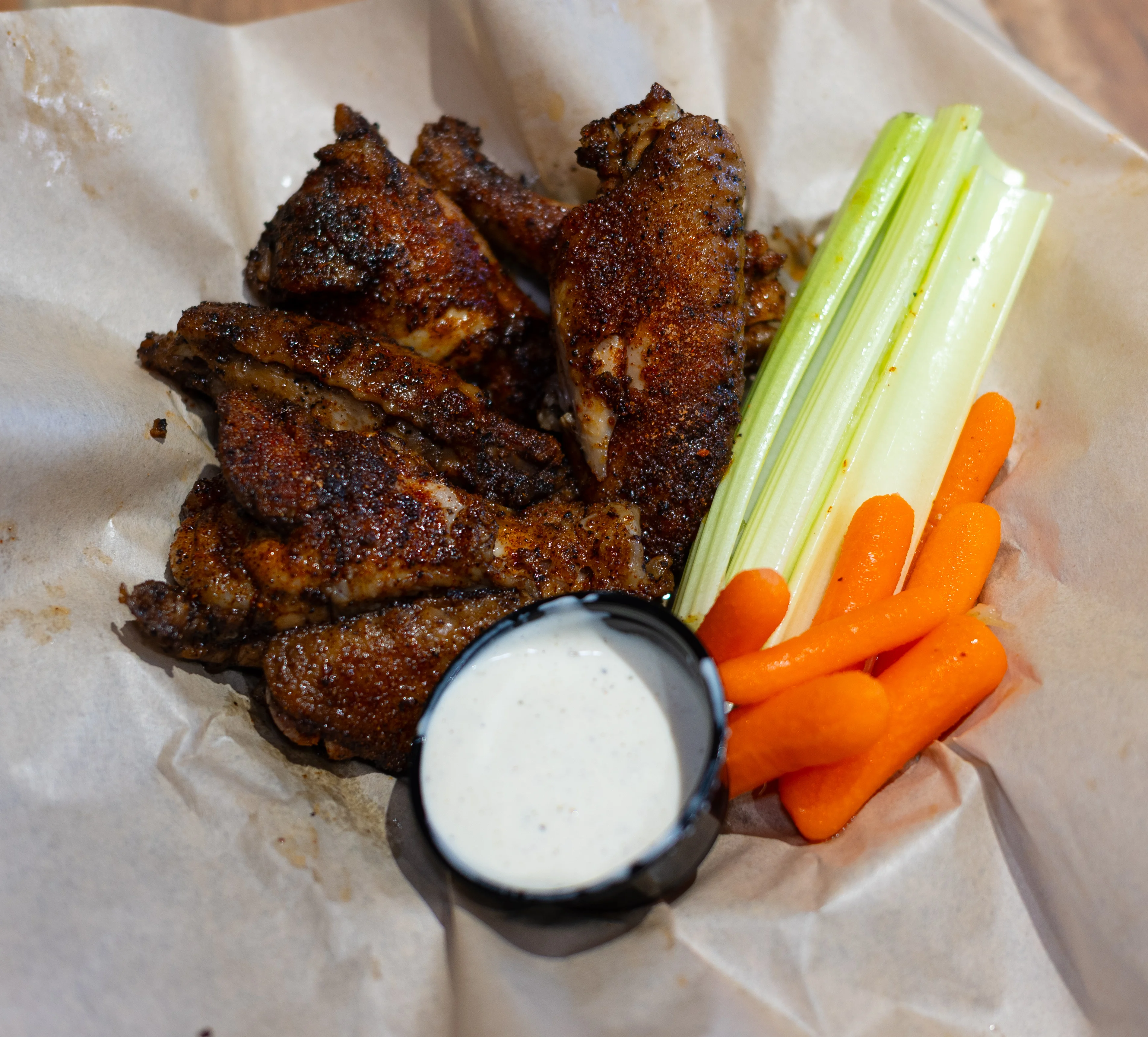 Crispy buffalo chicken wings with celery and carrots