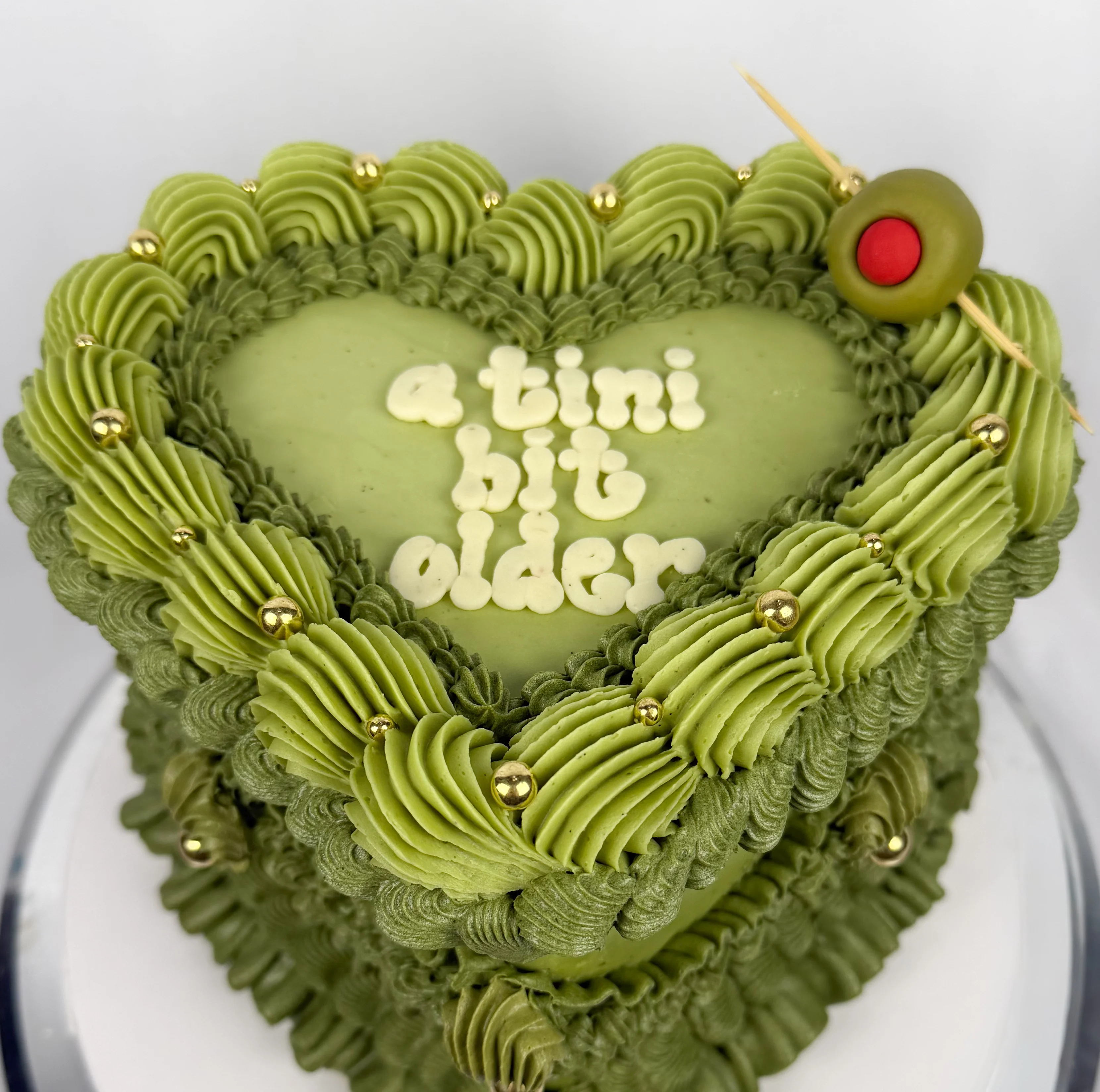 Heart-shaped matcha cake with decorative frosting
