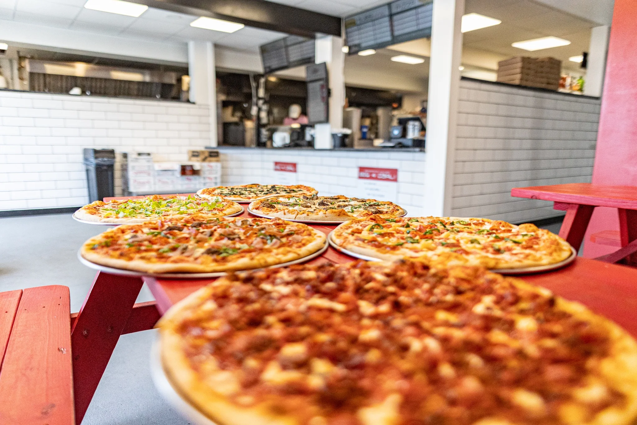 Variety of gourmet pizzas displayed in a casual dining setting