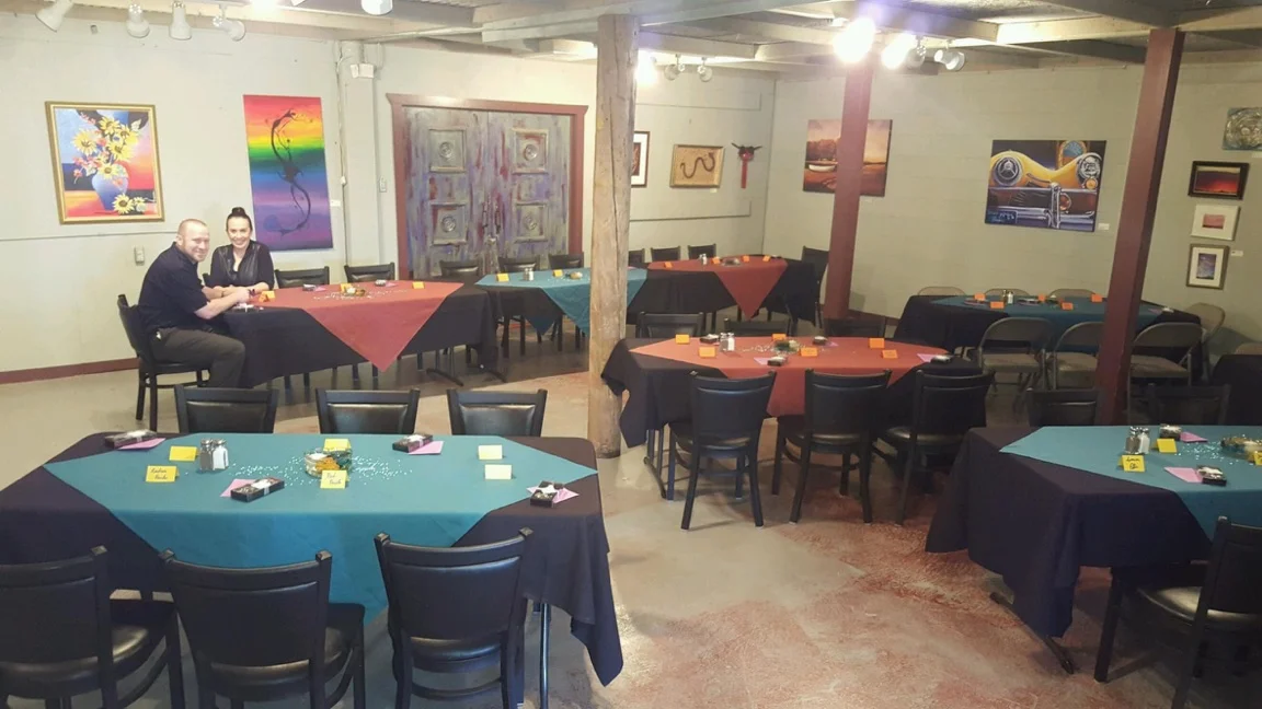 Cozy restaurant interior with colorful table settings and artwork