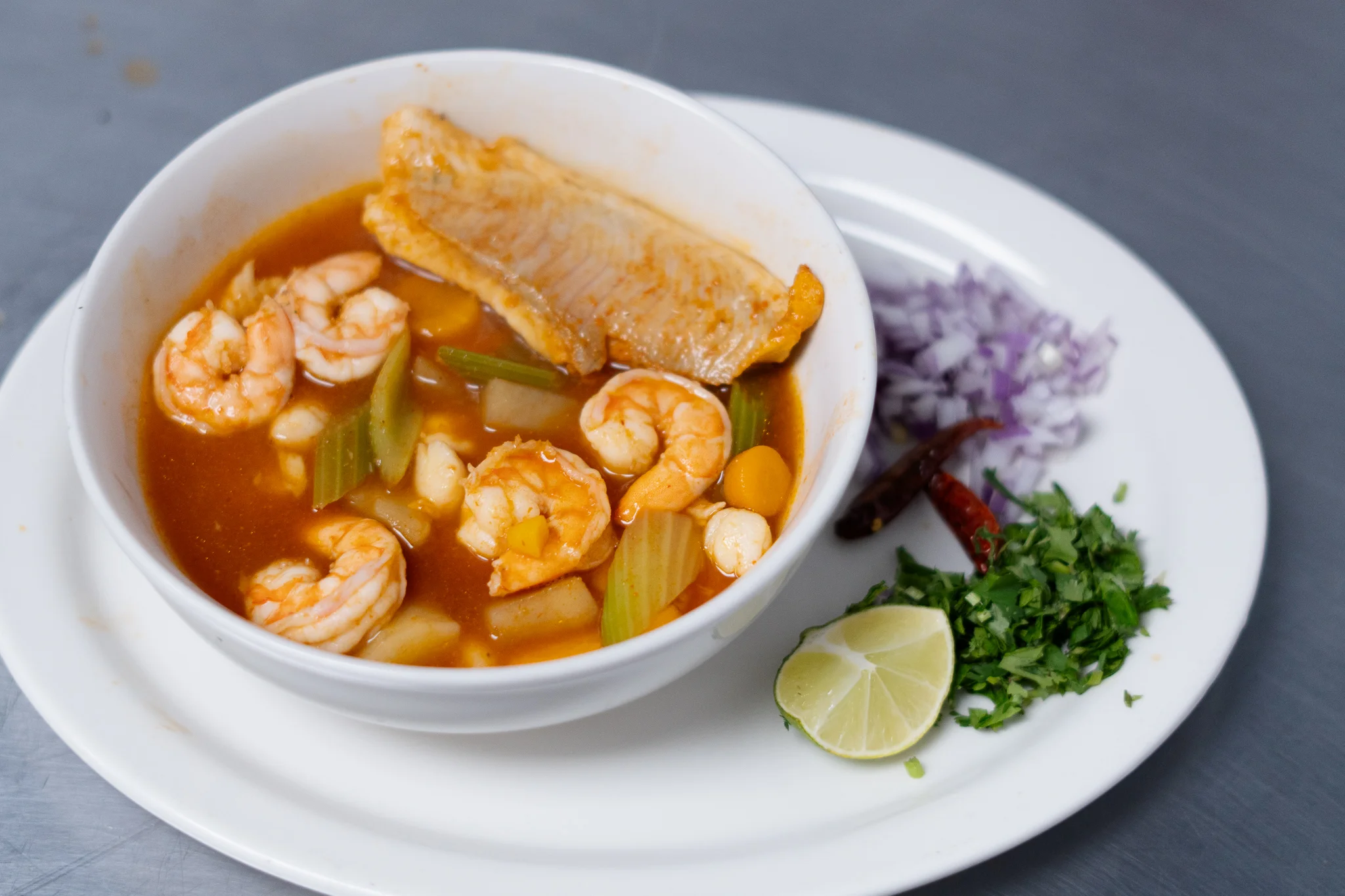 Spicy Thai tom yum soup with shrimp and herbs