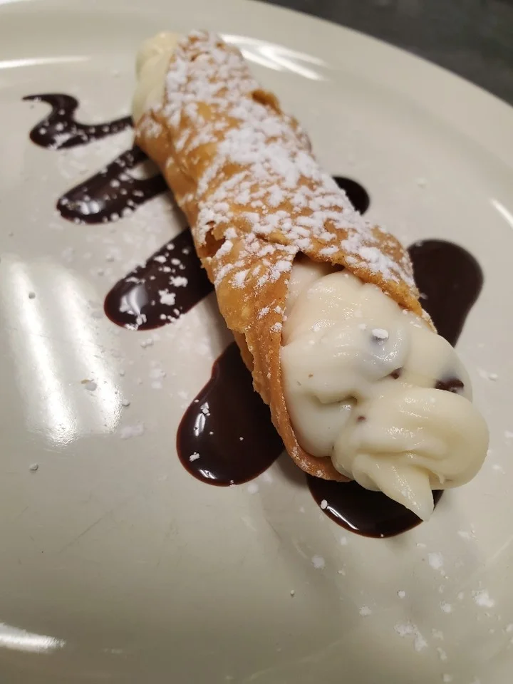 Classic Italian cannoli with chocolate drizzle