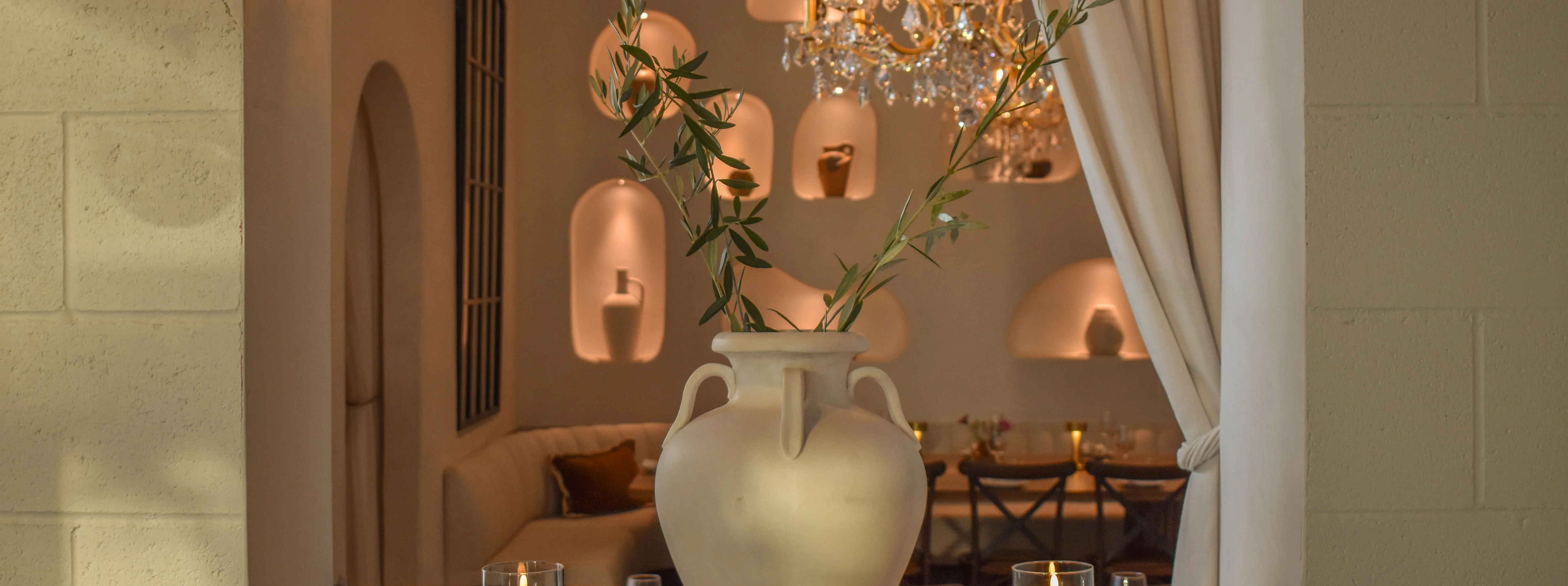 Elegant restaurant interior with a decorative vase and warm lighting