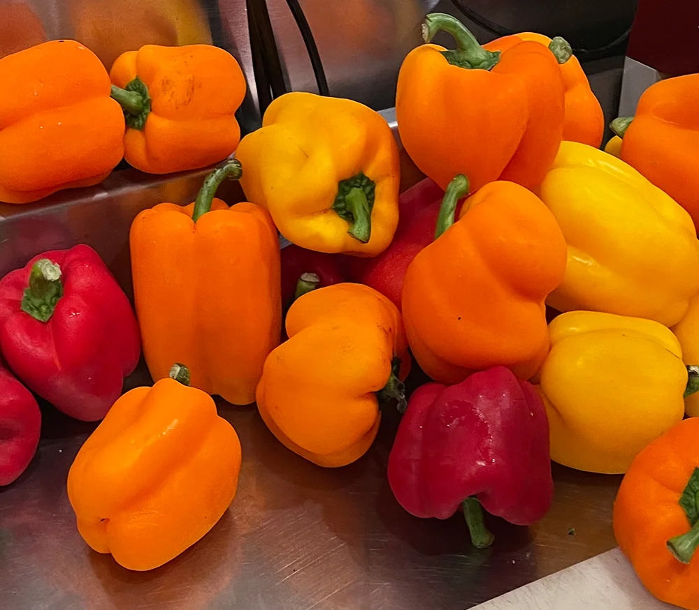 Colorful bell peppers ready for cooking in a vibrant kitchen