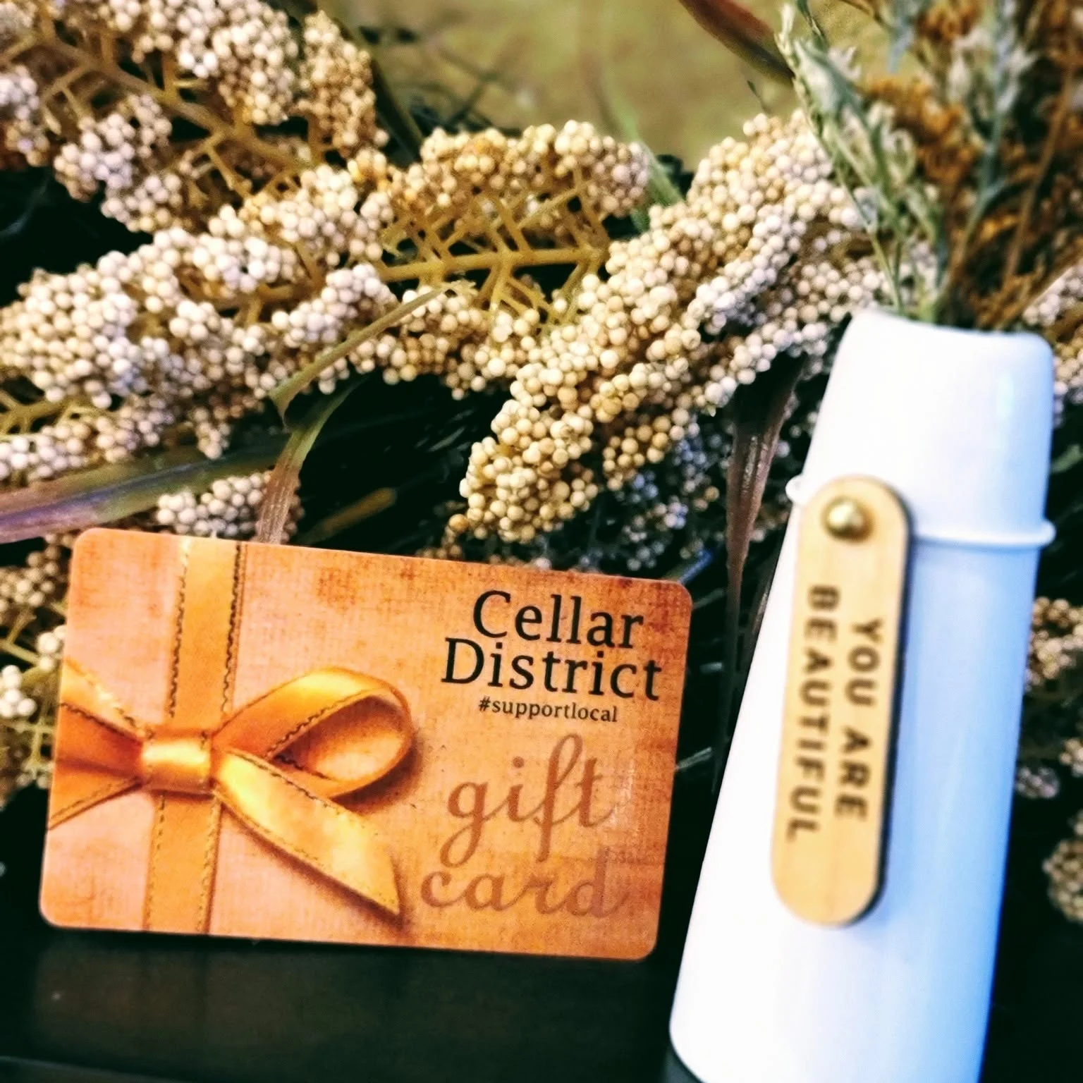 Gift card from Cellar District with decorative flowers