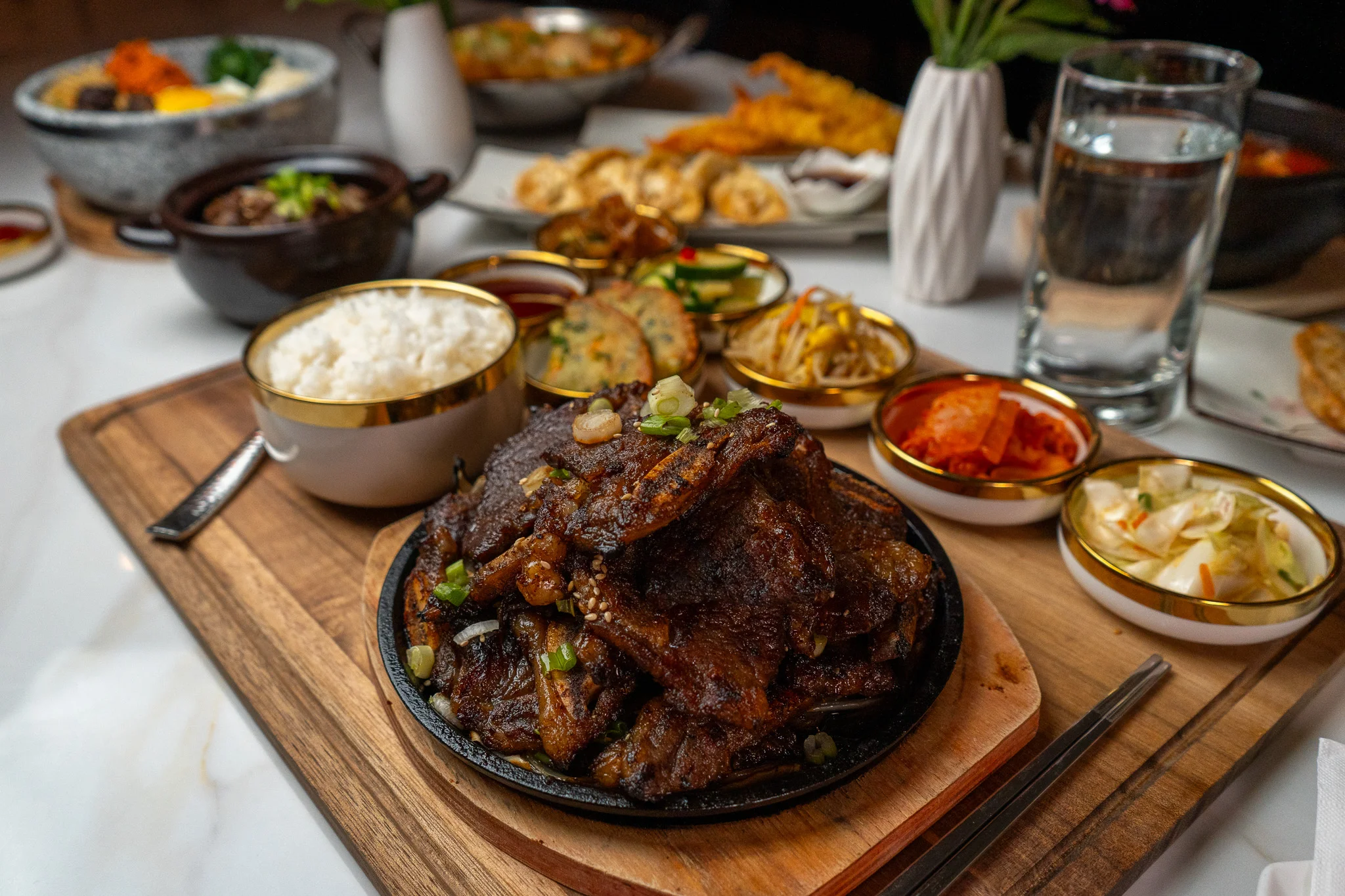 Sizzling Korean galbi served with rice and side dishes