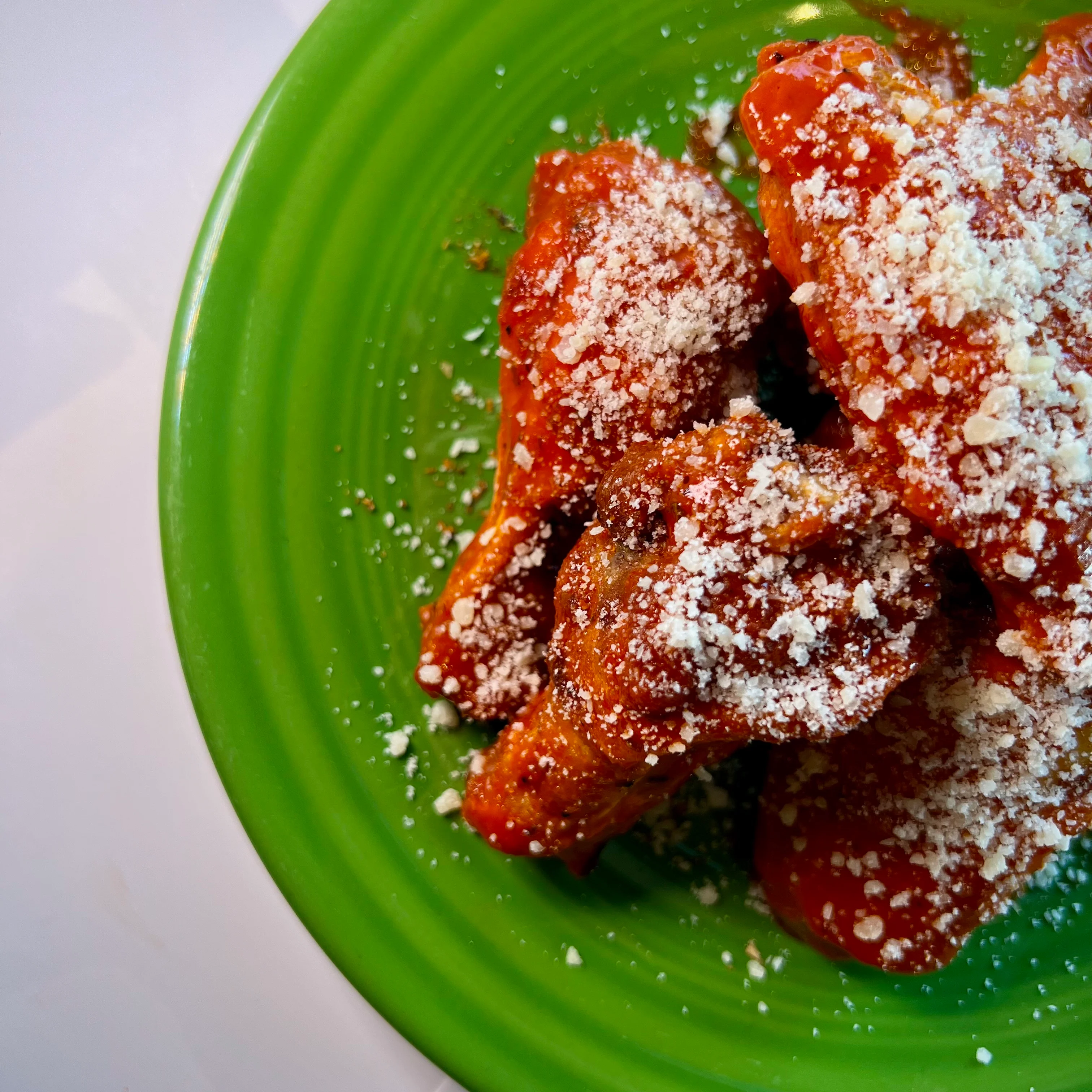 Spicy buffalo wings topped with cheese