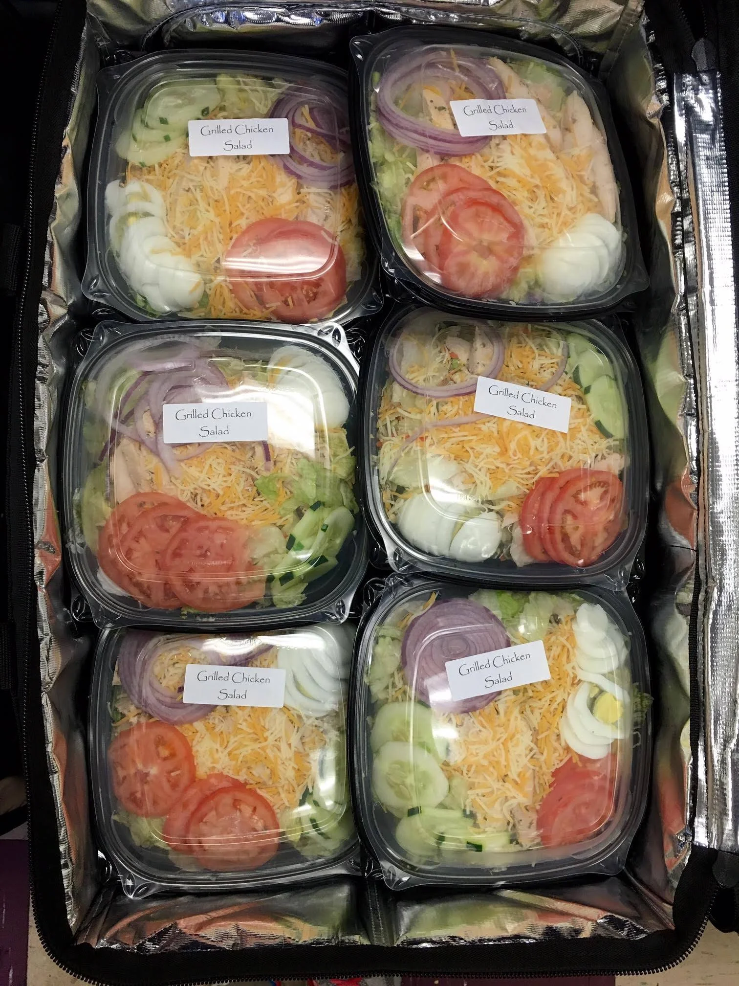 Grilled chicken salad in meal prep containers