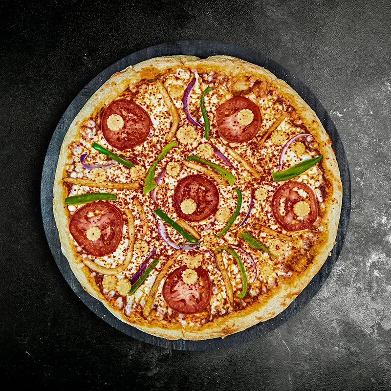 Vegetarian pizza topped with fresh tomatoes and bell peppers