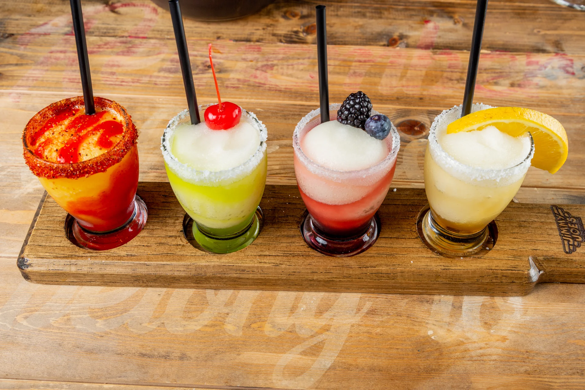 Colorful frozen margaritas served in shot glasses