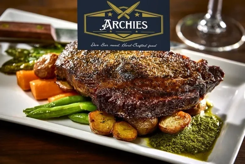 A ribeye on a plate of veggies