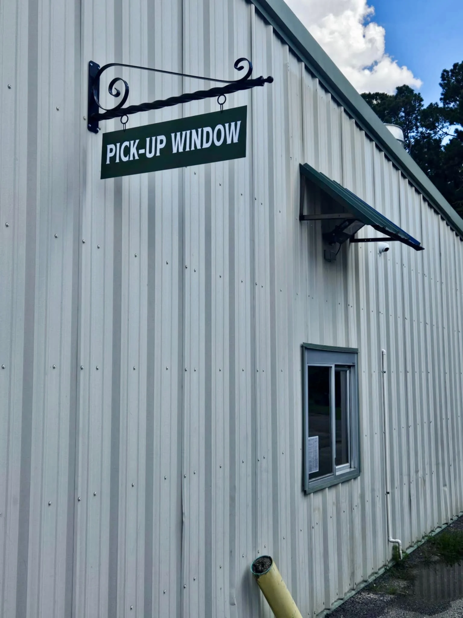 Pick-up window sign at a restaurant exterior