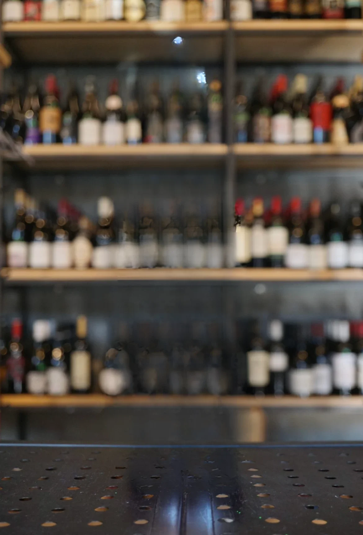 Well-stocked wine shelf in a modern bar