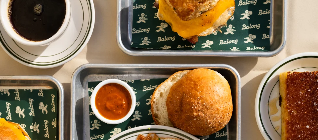 Classic American breakfast with eggs, biscuit, and coffee on a tray