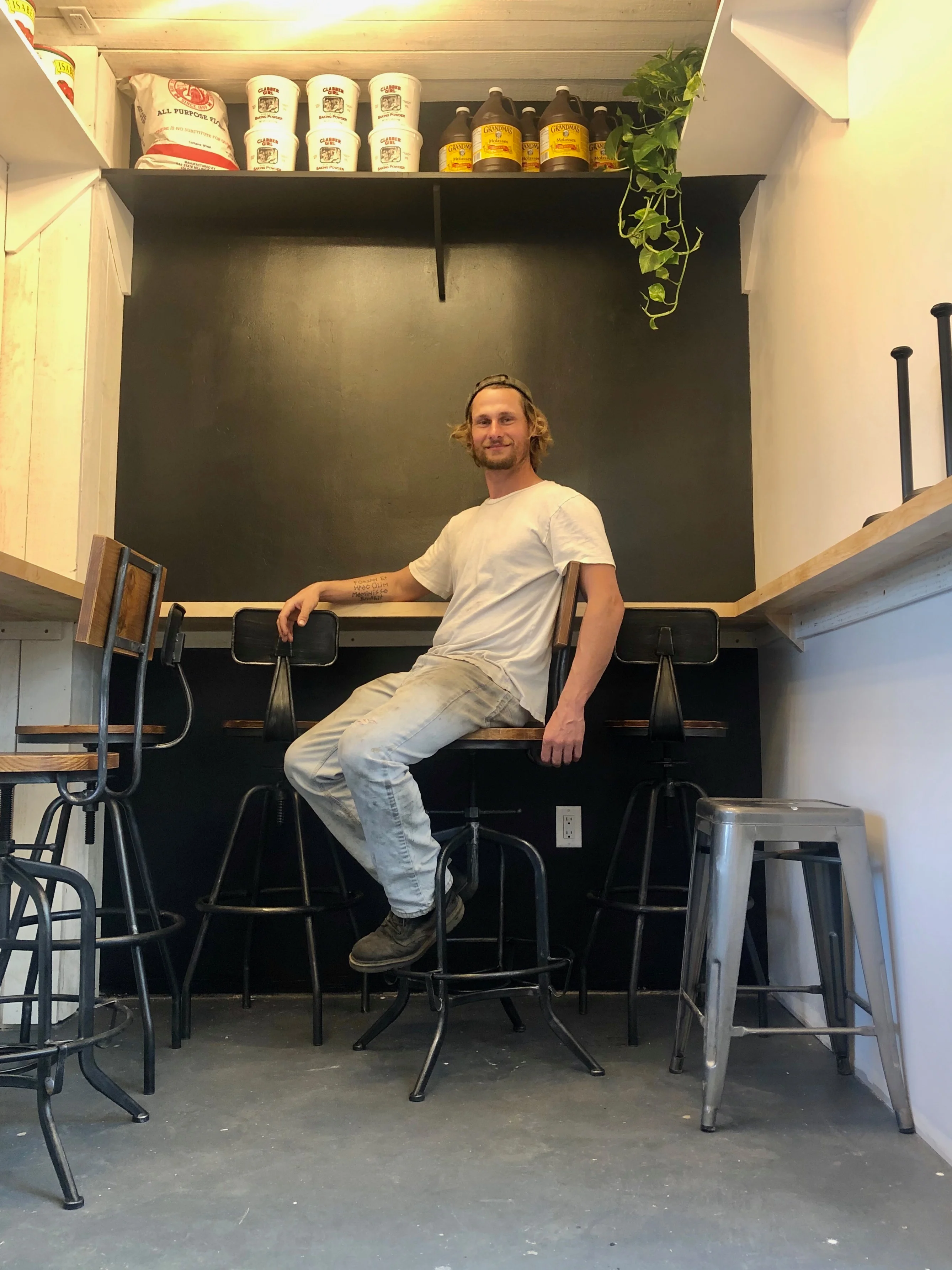 Cozy restaurant interior with bar stools and shelves