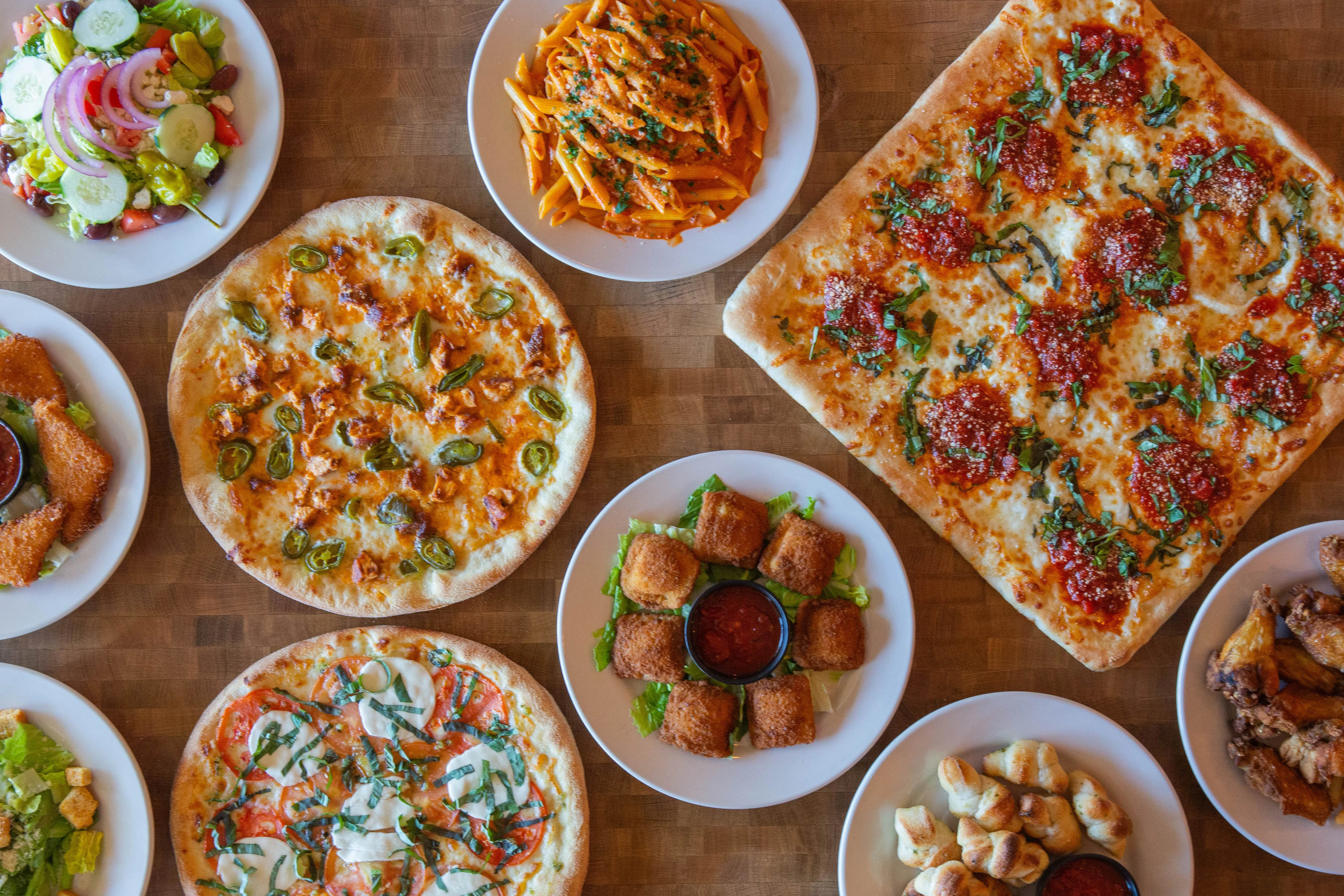 Assorted Italian dishes including pizzas and pasta