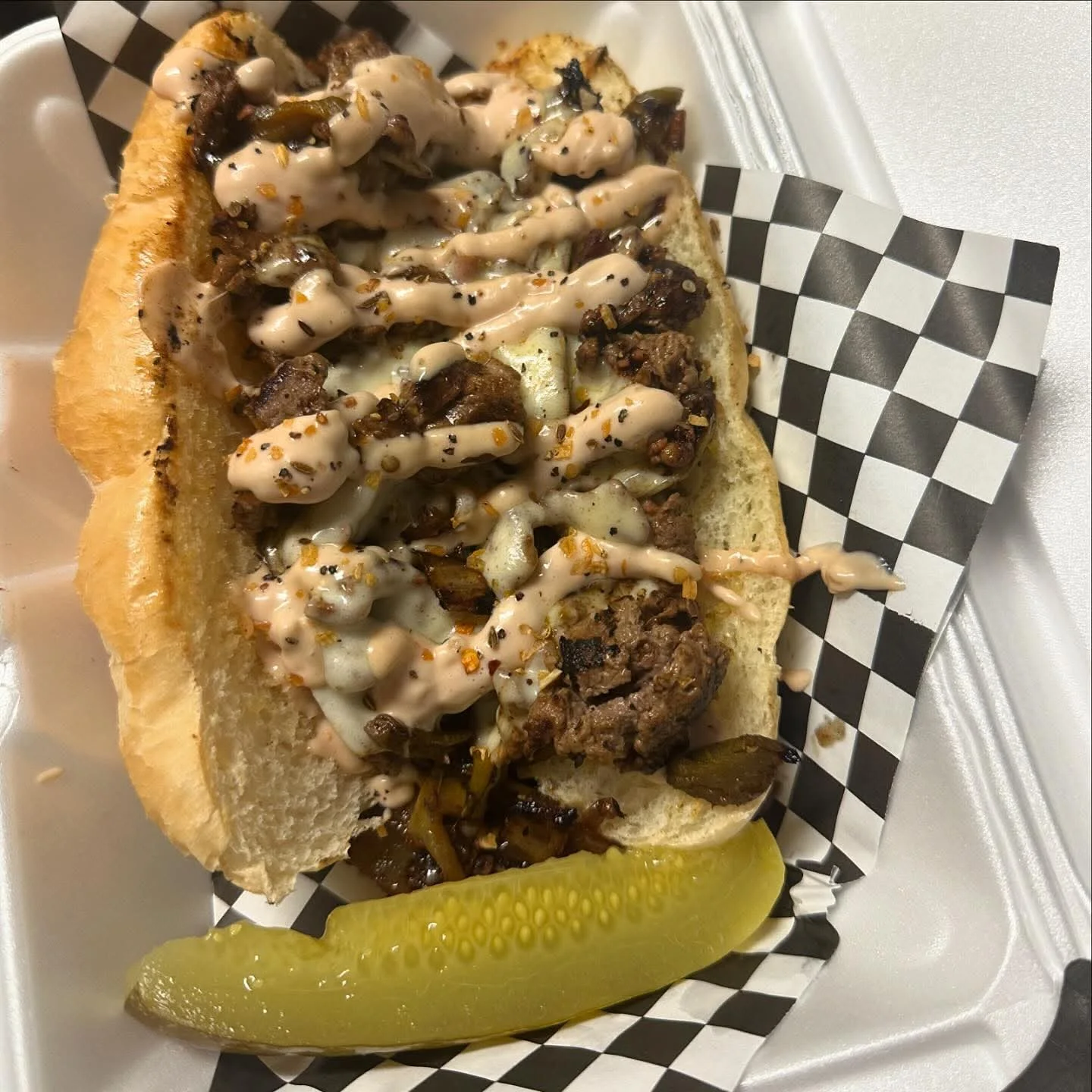 Loaded cheesesteak sandwich with spicy sauce
