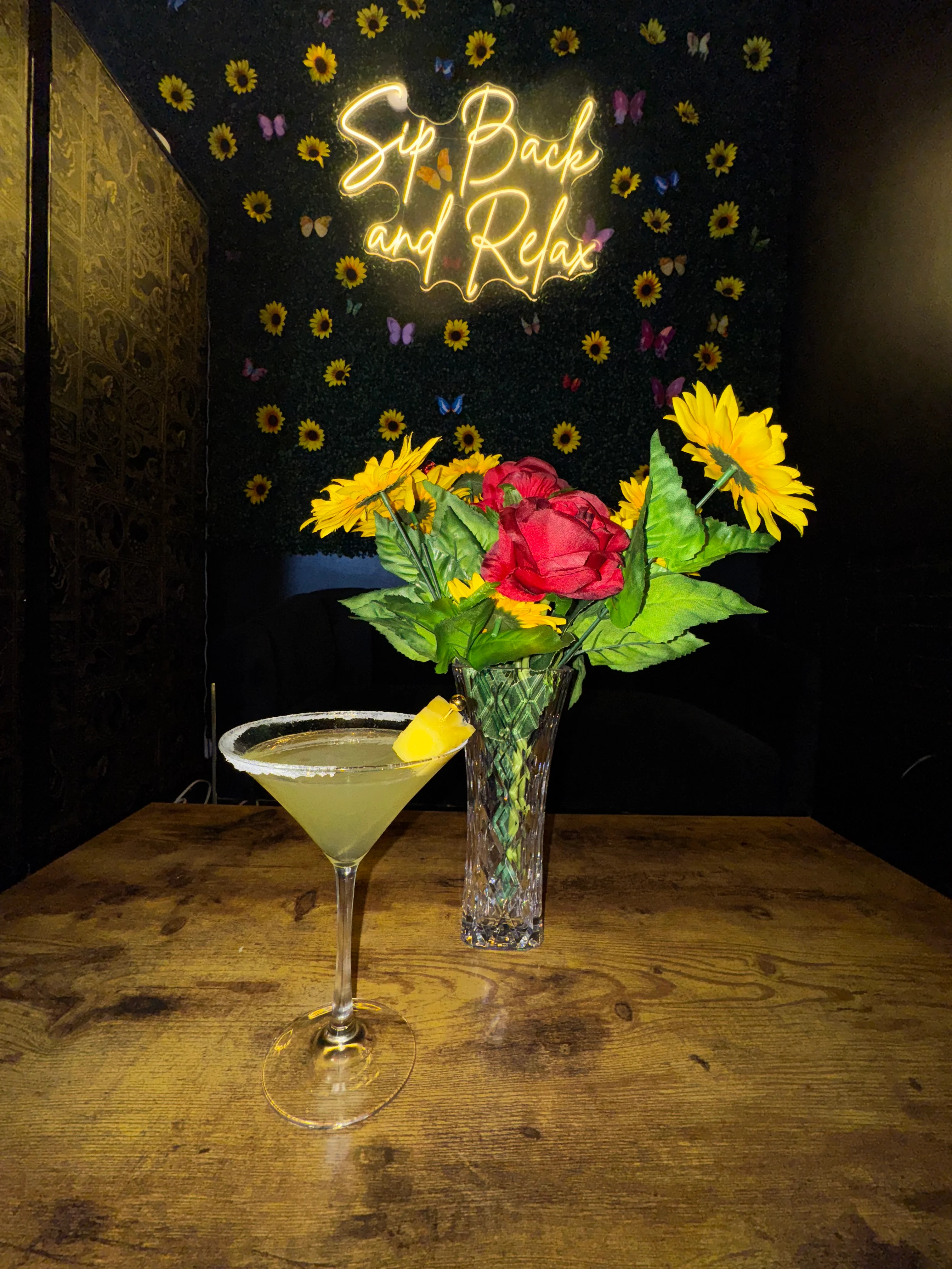 Refreshing cocktail with lemon garnish in a cozy bar setting