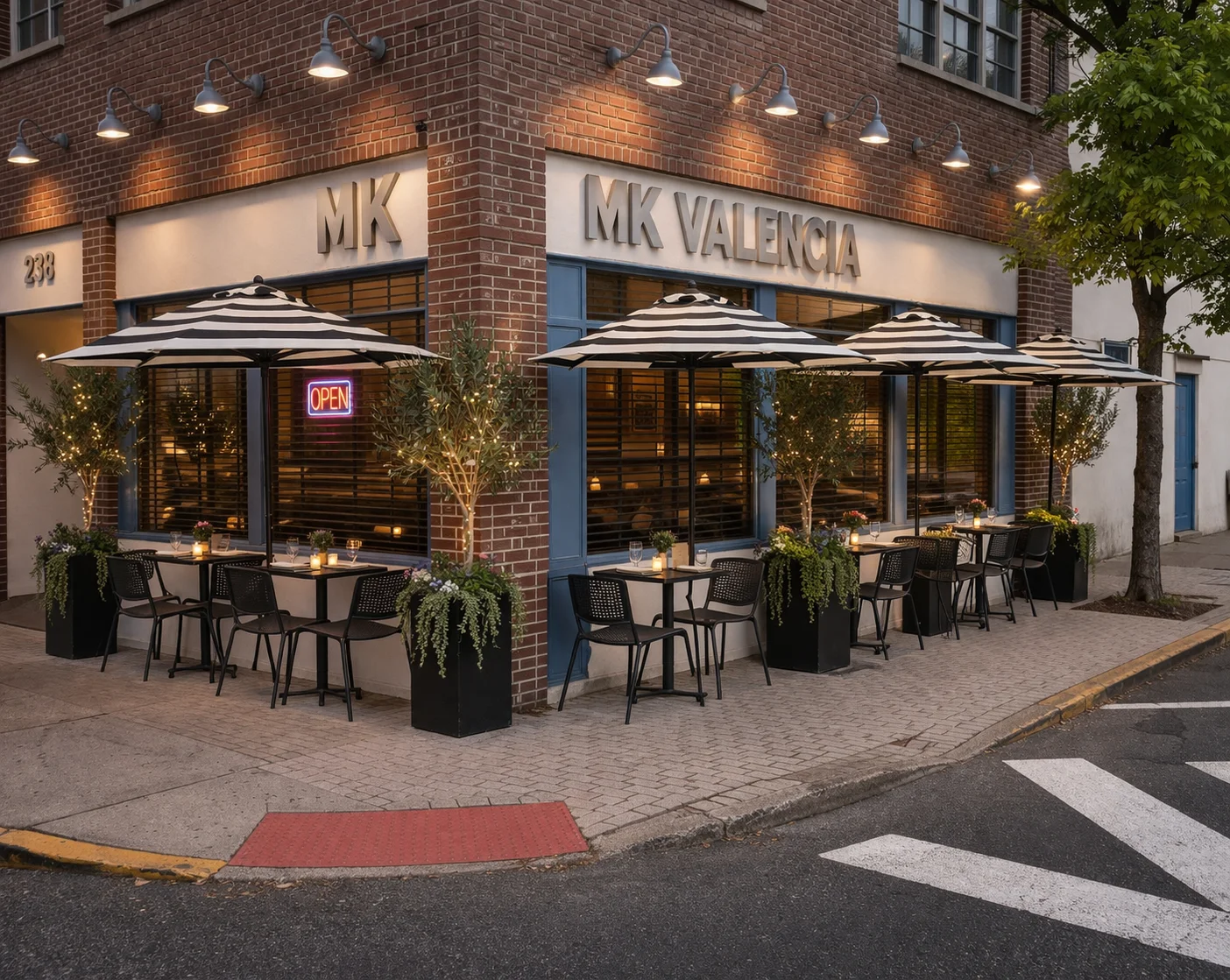 An elegant restaurant interior featuring a series of tables set for dining alongside a well-stocked bar. Soft lighting and large windows create a welcoming atmosphere.