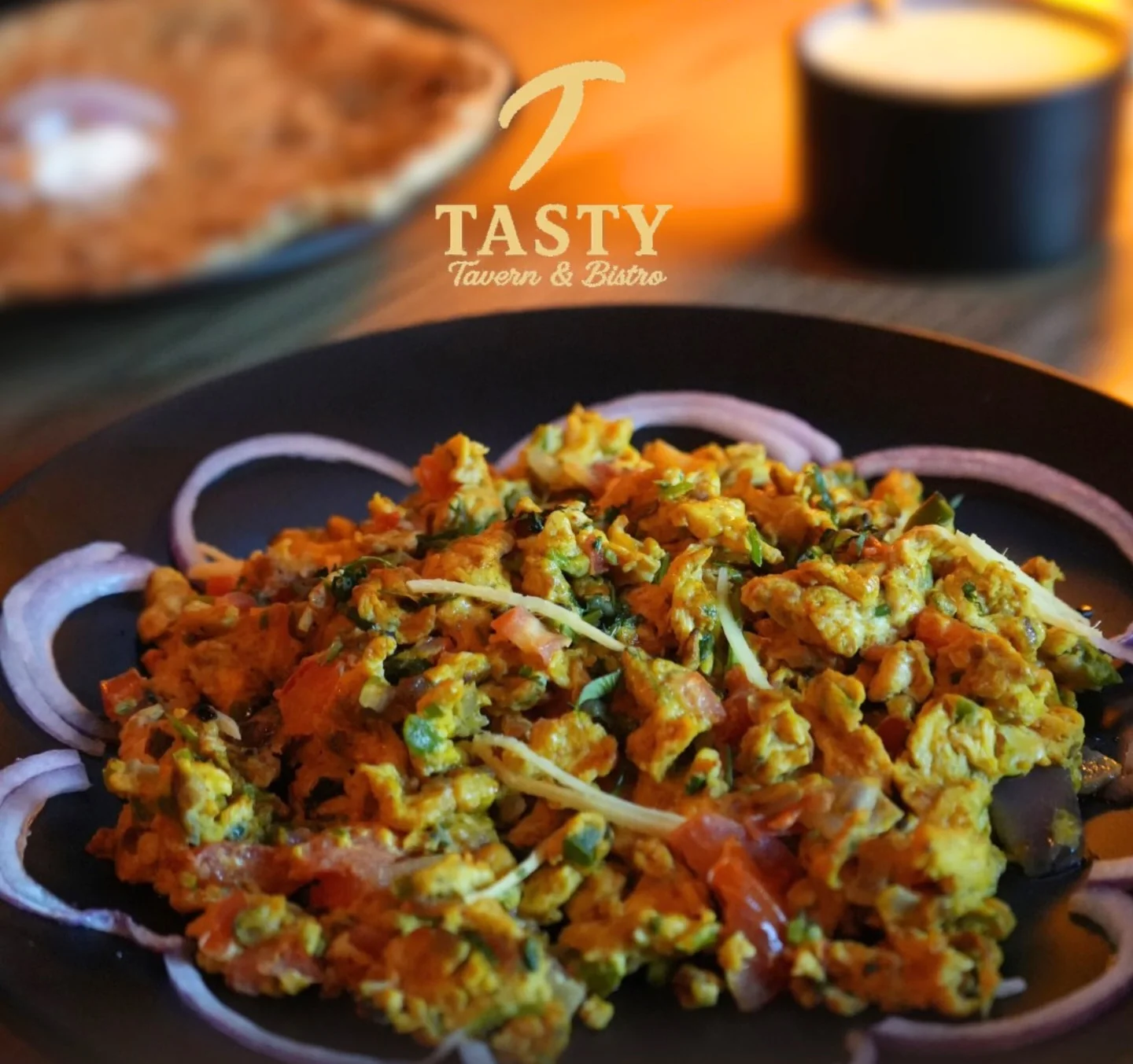 Spicy Indian bhurji served with onions for Sunday brunch