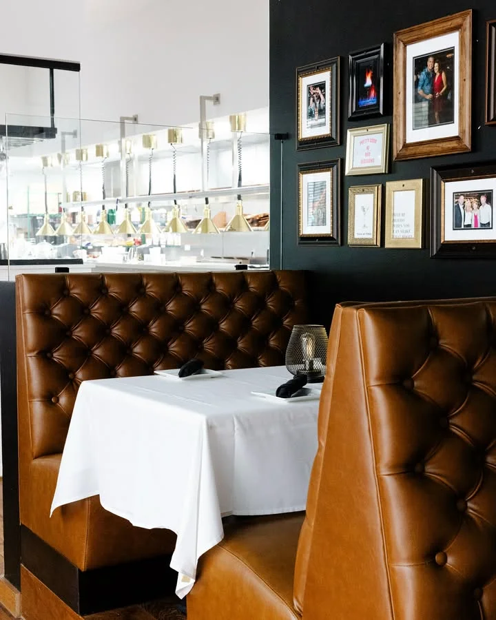Cozy restaurant booth with elegant decor and framed photos