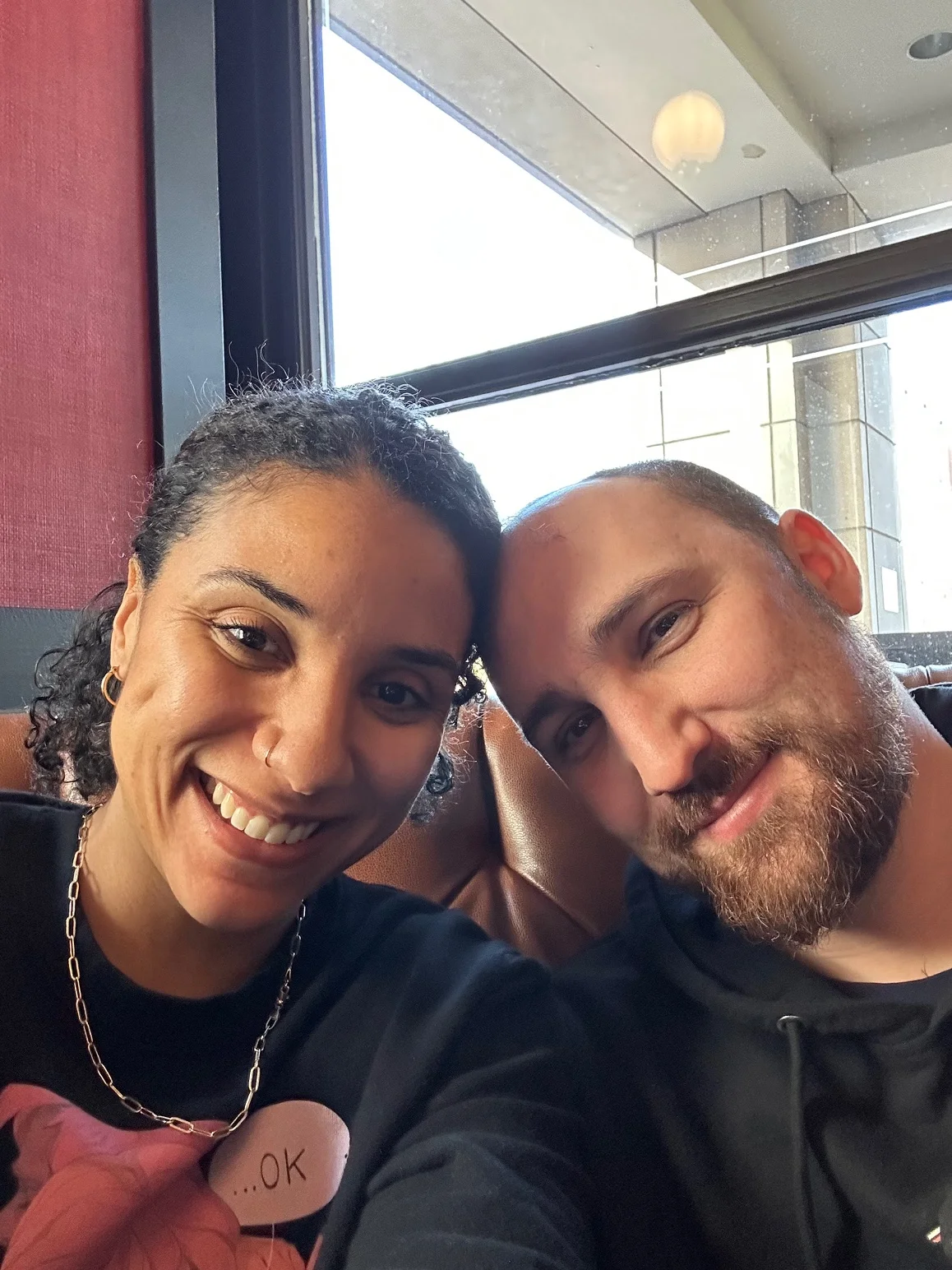 Couple smiling together in a cozy restaurant setting