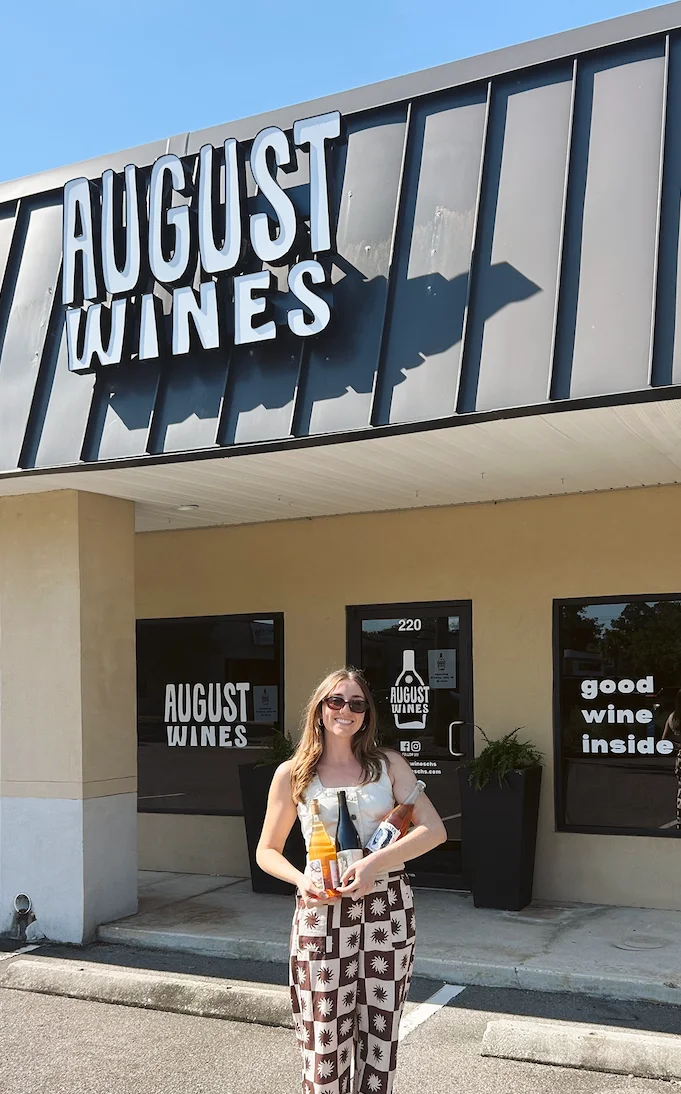 Customer outside August Wines holding bottles
