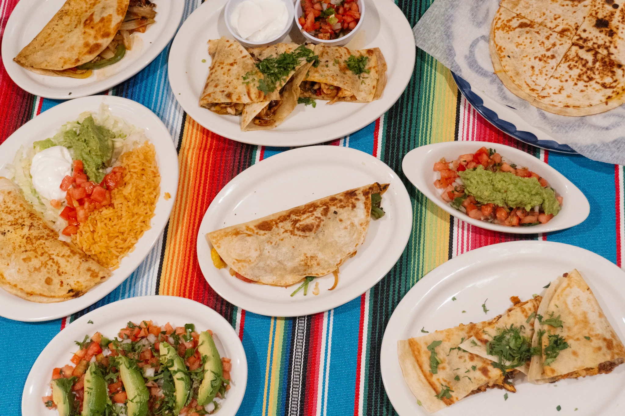 Colorful Mexican platter with quesadillas, guacamole, and fresh salsa